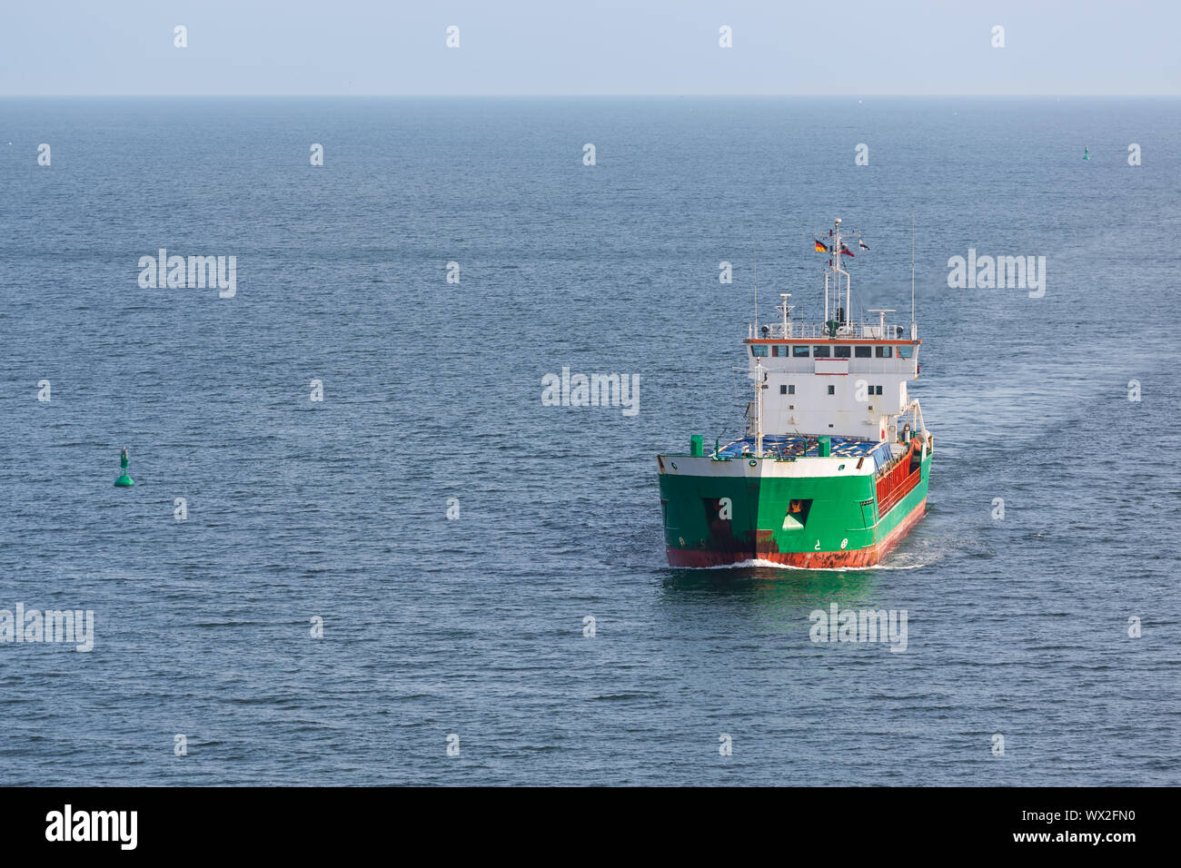 Aerial view of a freighter sailing at the big blue sea Stock Photo