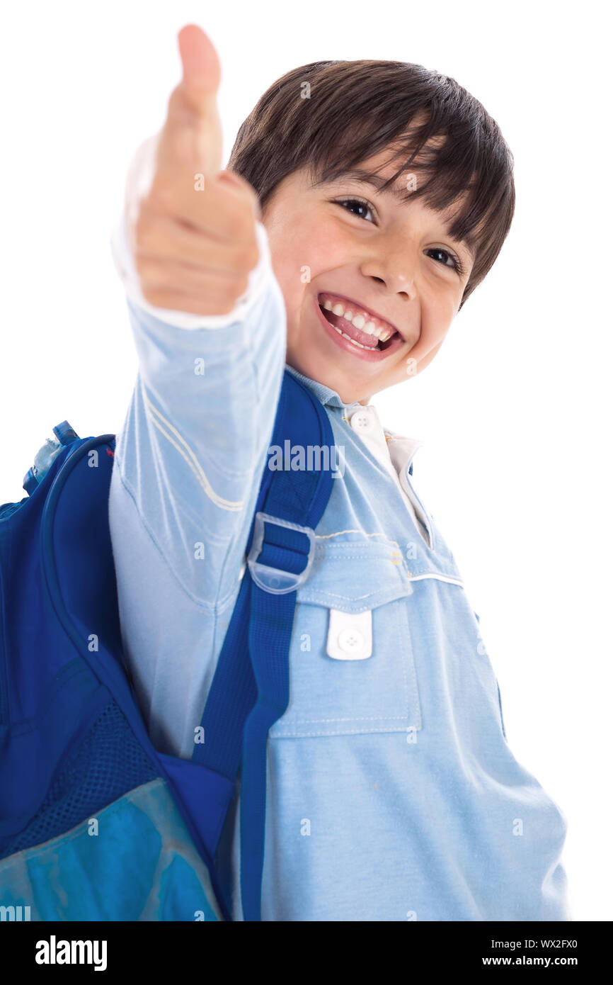 Smiling kinder garden boy gives thumbs up on isolated white background ...