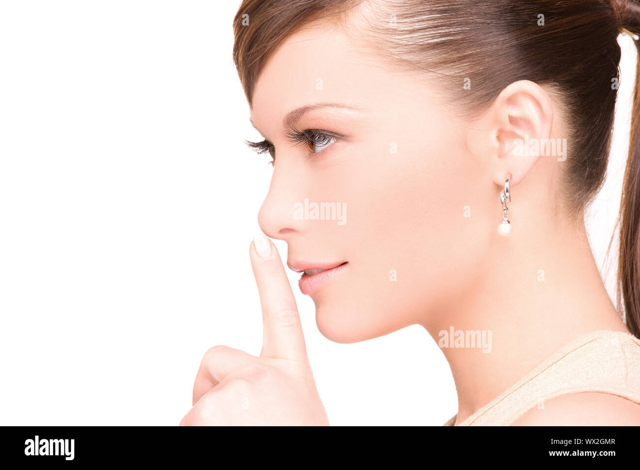 bright picture of young woman with finger on lips Stock Photo - Alamy