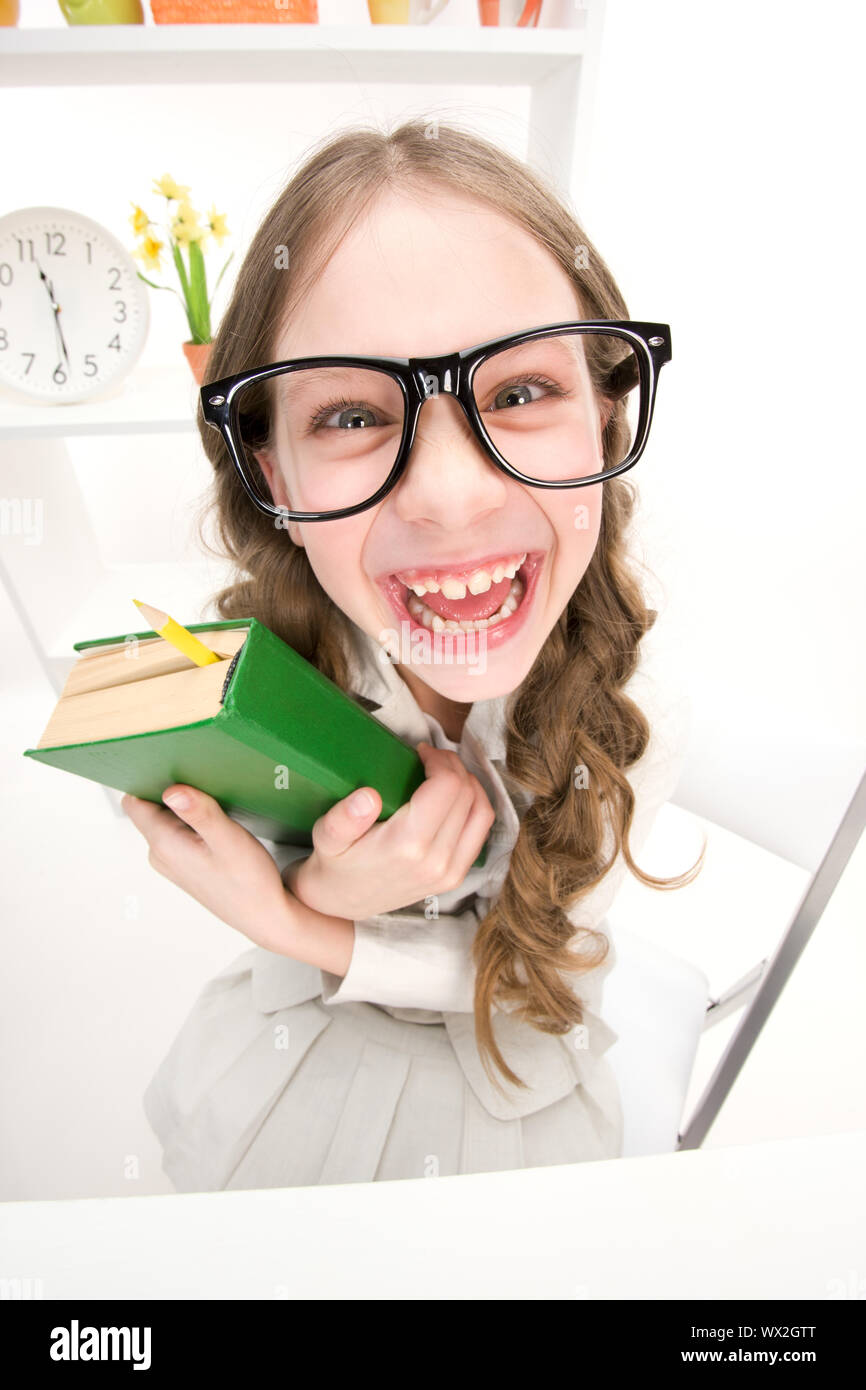 wideangle distorted picture of funny girl with green book Stock Photo