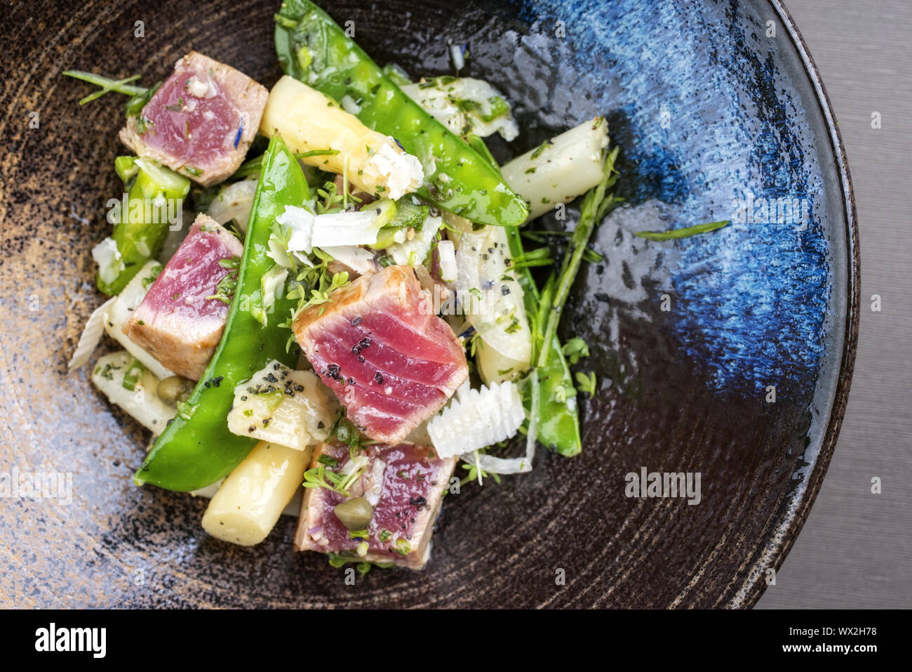 Modern fried tuna fish tataki filet salad with white asparagus sugar