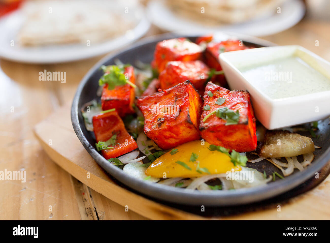 close up of paneer tikka dish with sauce on table Stock Photo