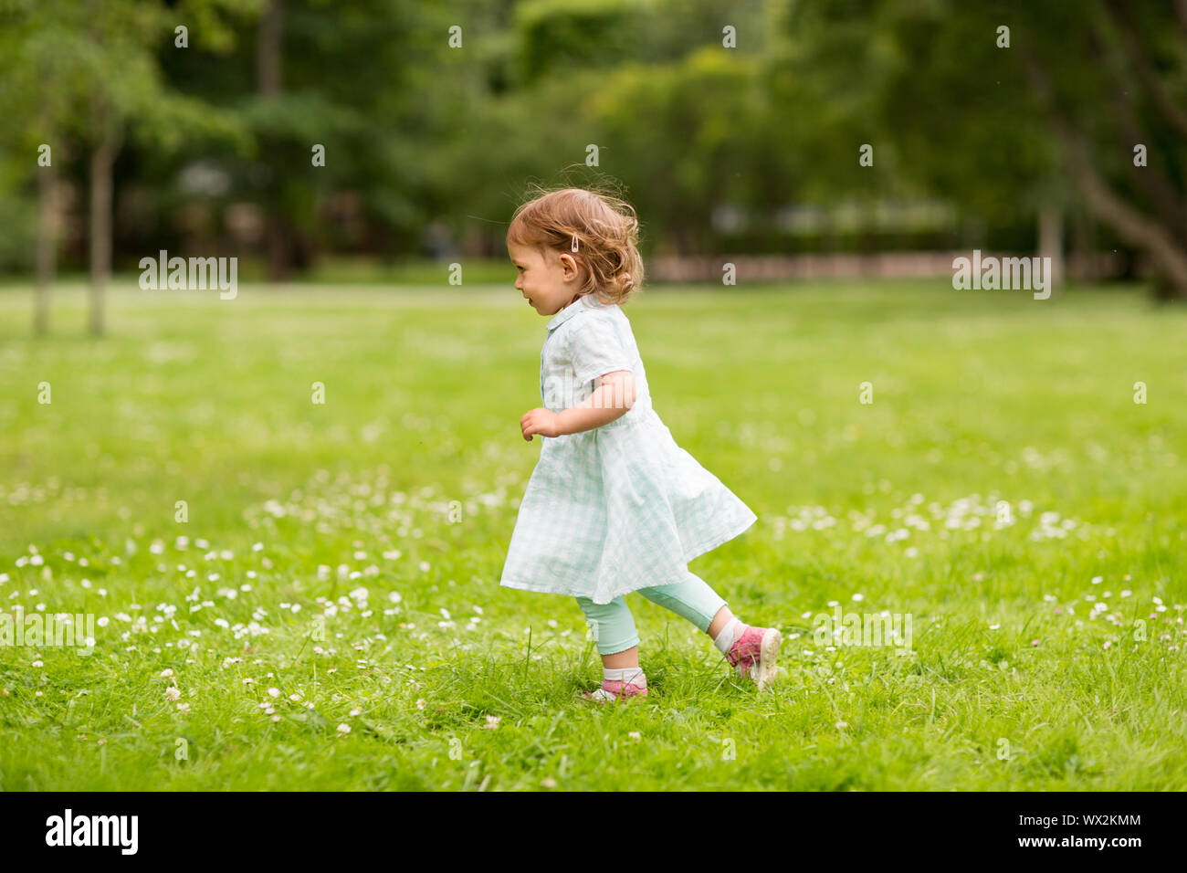happy little baby girl running at park in summer Stock Photo - Alamy