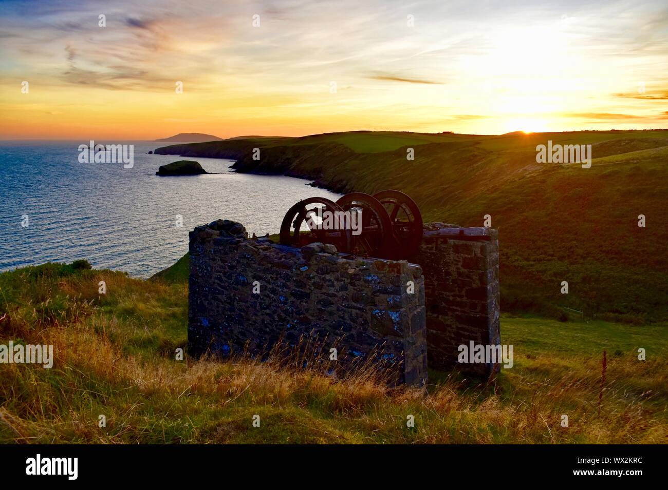 Nant Gadwen Mine upper drumhouse at sunset, looking out over Aberdaron Bay. Stock Photo