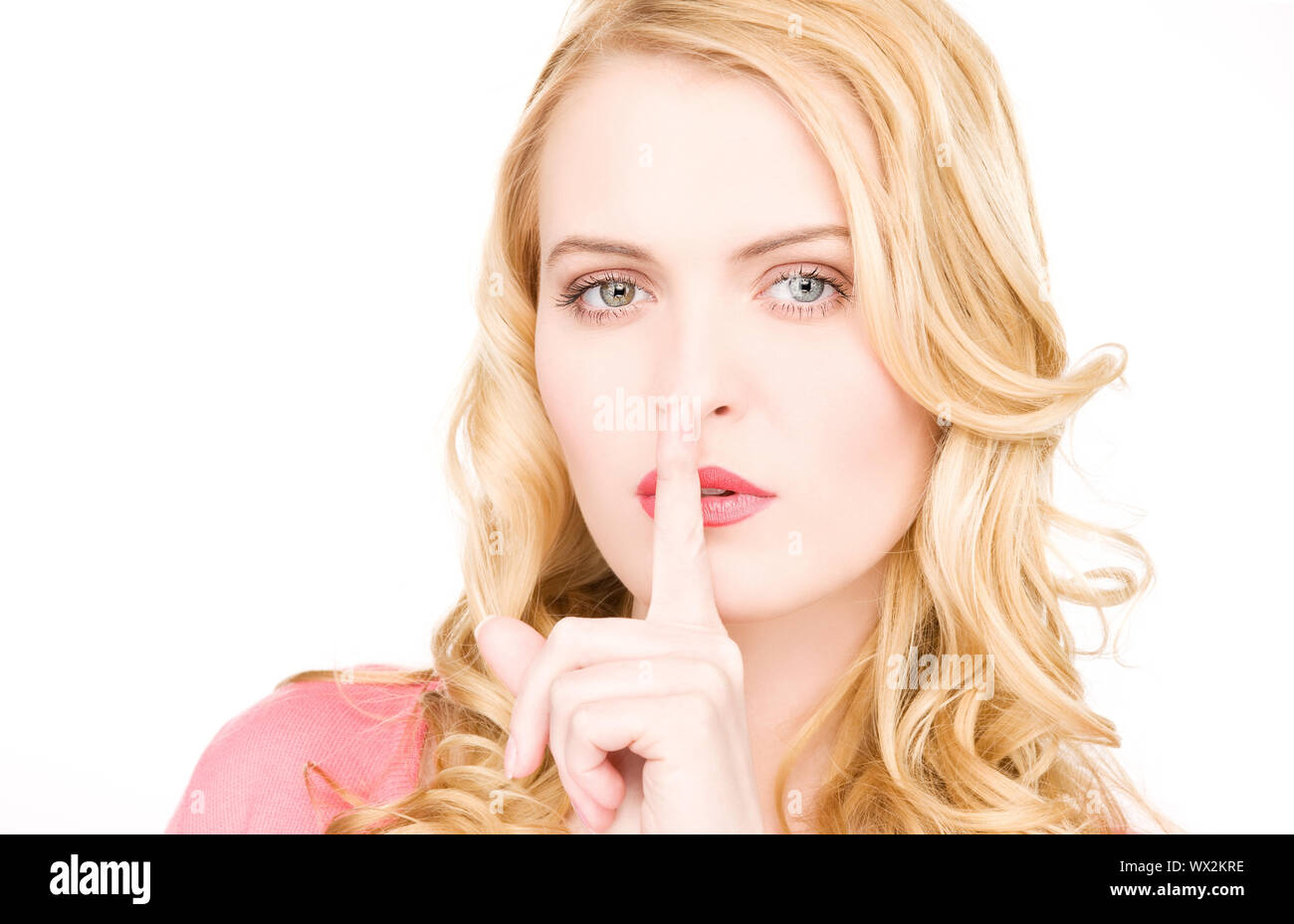 bright picture of young woman with finger on lips Stock Photo - Alamy