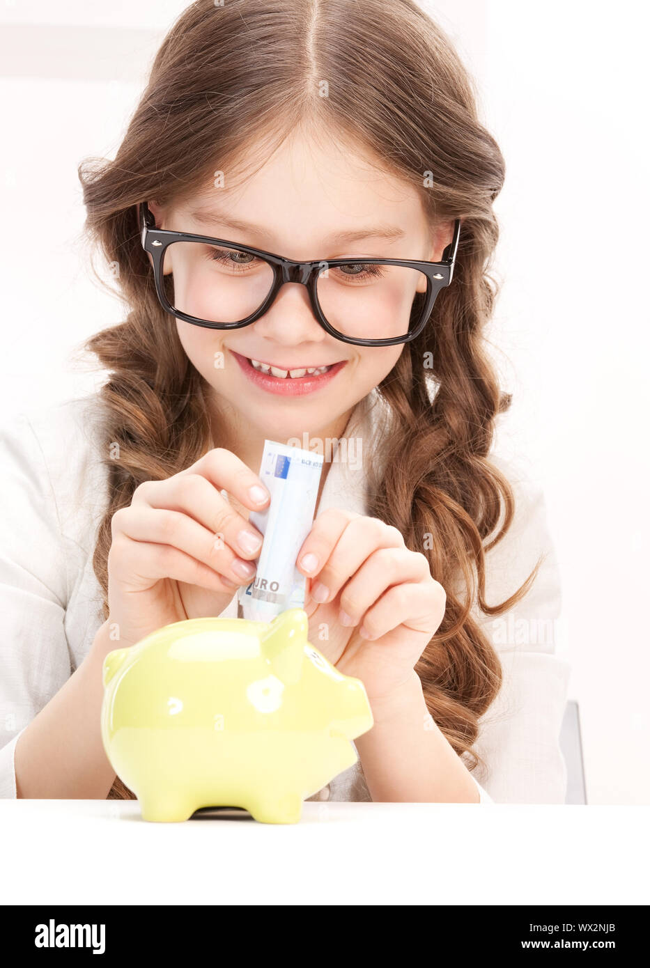 little girl with piggy bank and money Stock Photo - Alamy