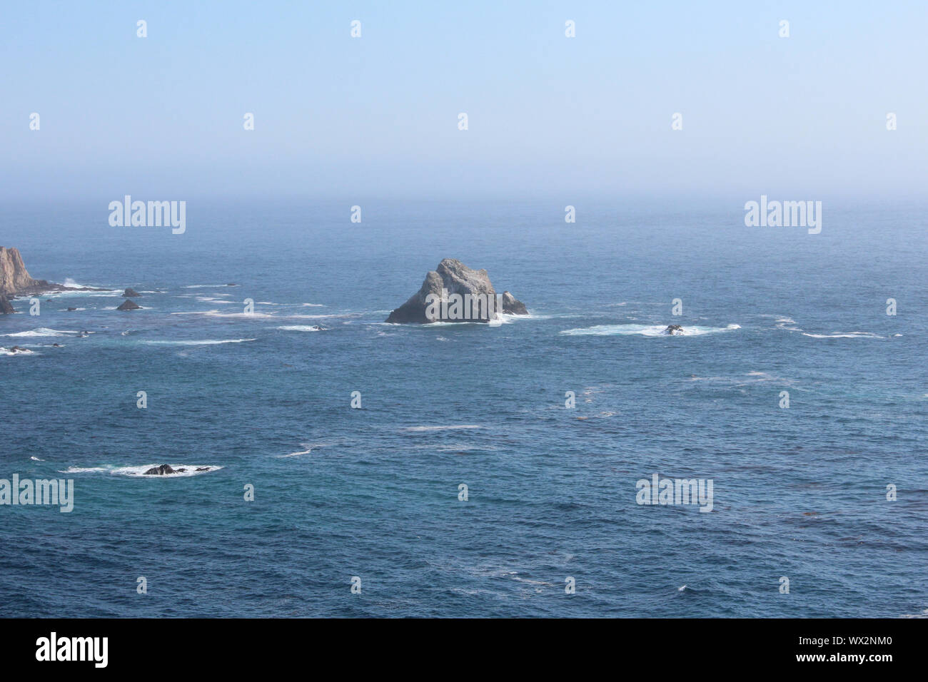 View of a small rock island in the Pacific Ocean close to Pacific Coast Highway, California, USA Stock Photo