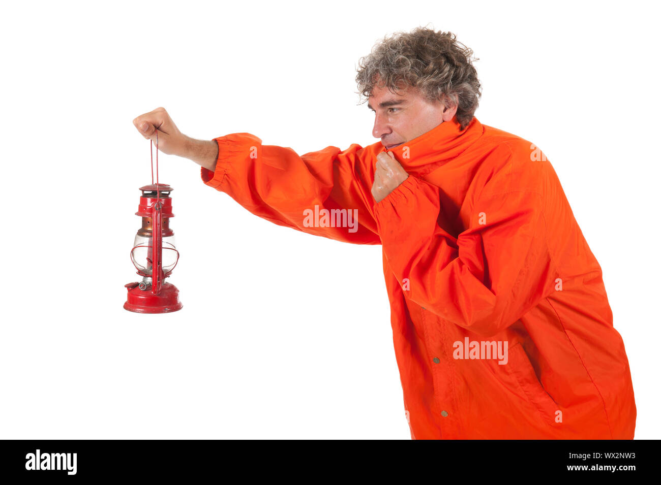 Man walking in bad weather with oil lamp Stock Photo Alamy