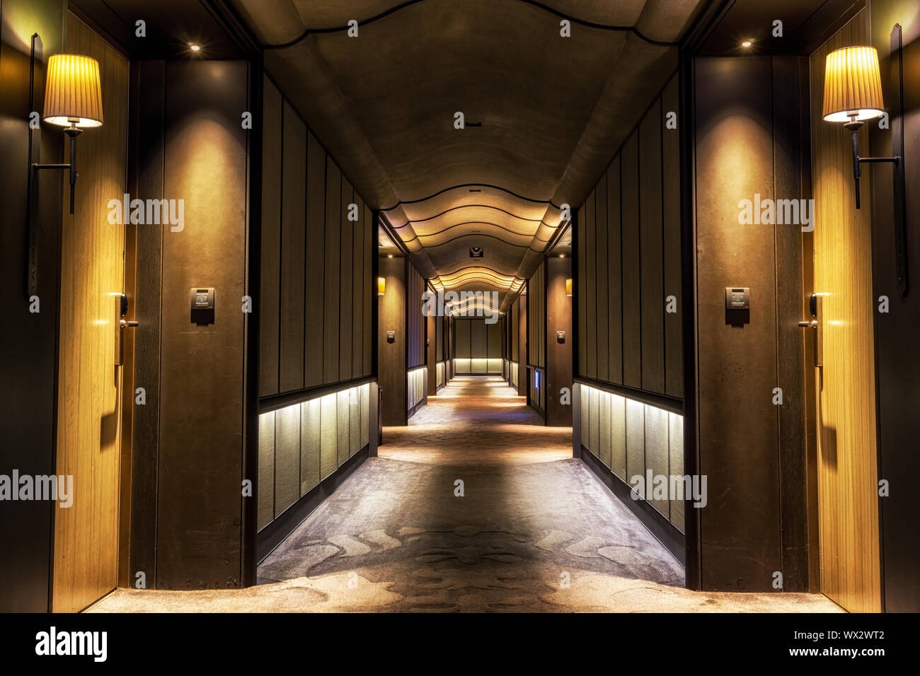 Long dark hotel corridor Stock Photo