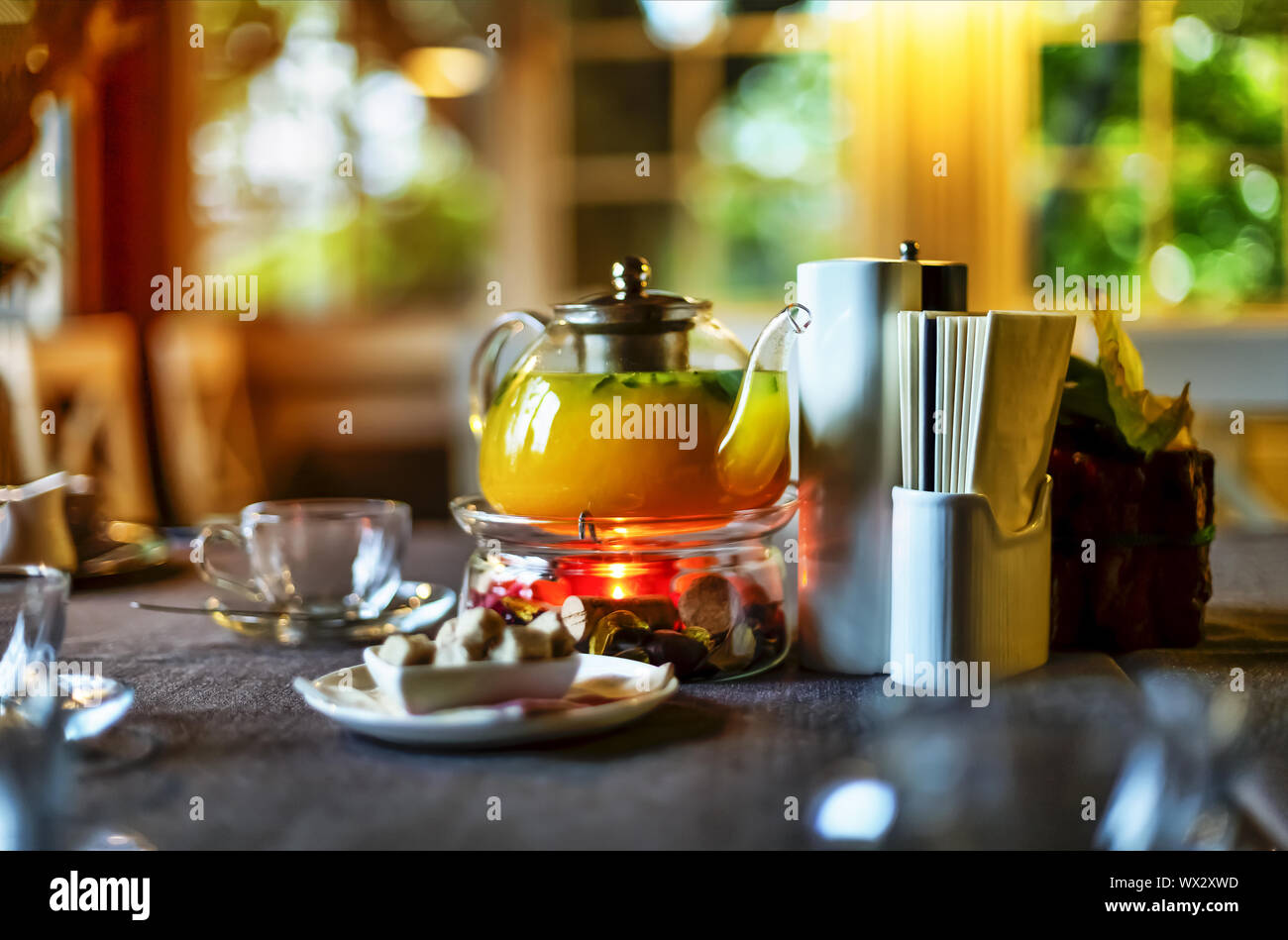 Sea buckthorn tea, Full teapot, served at the table,  restaurant Stock Photo