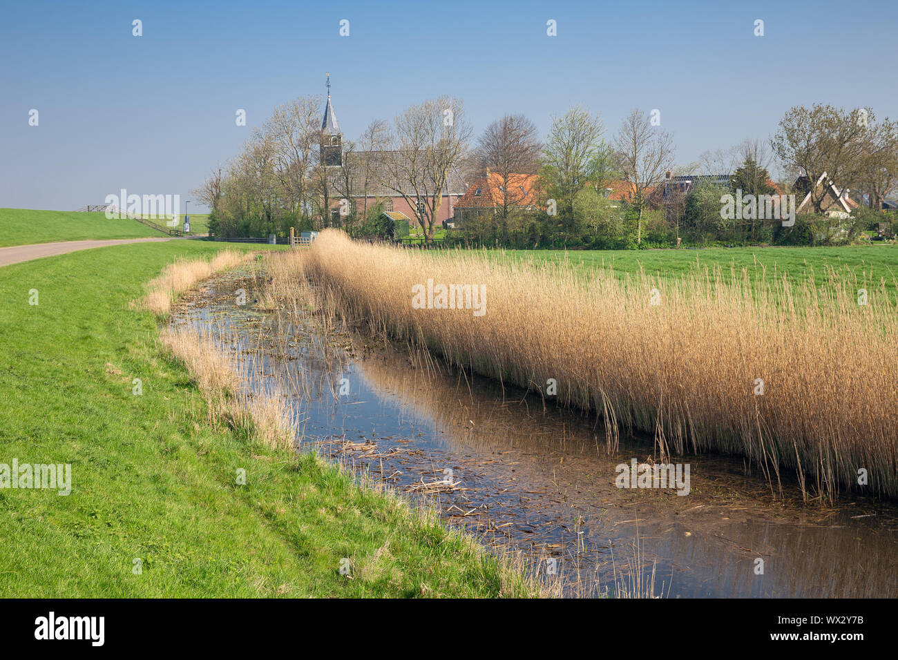 Dutch village Gaast with church behind dam for sea protection Stock ...