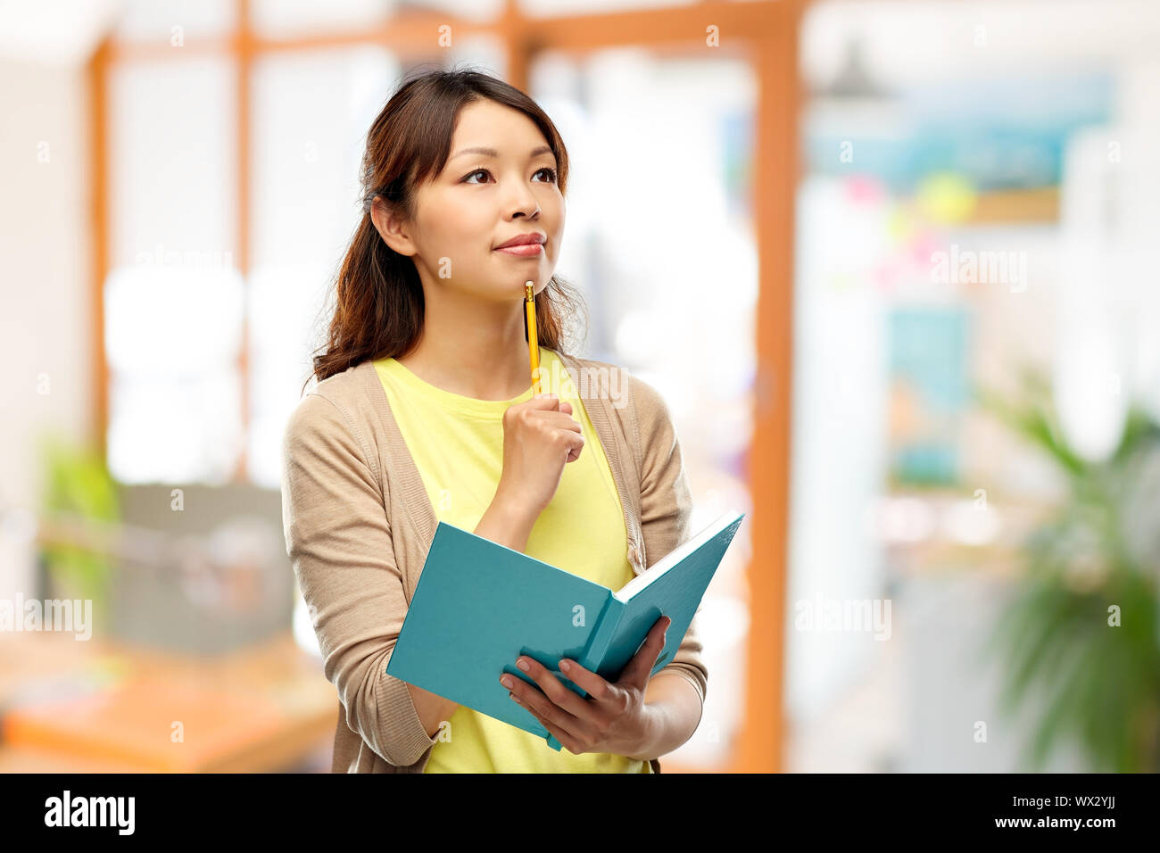 Woman thinking holding pencil hi-res stock photography and images - Alamy