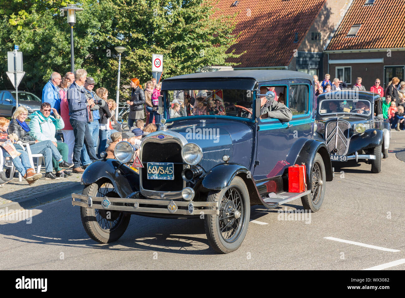 Oldtimer cars in a countryside parade agricultural festival, the Netherlands Stock Photo