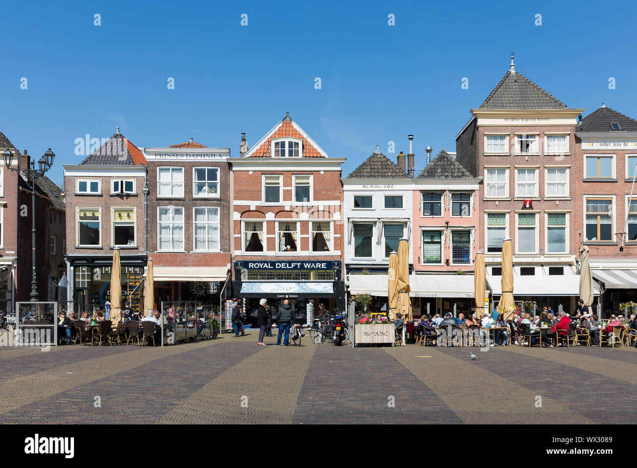 Townscape with people sitting on terraces of Delft, the Netherlands Stock Photo