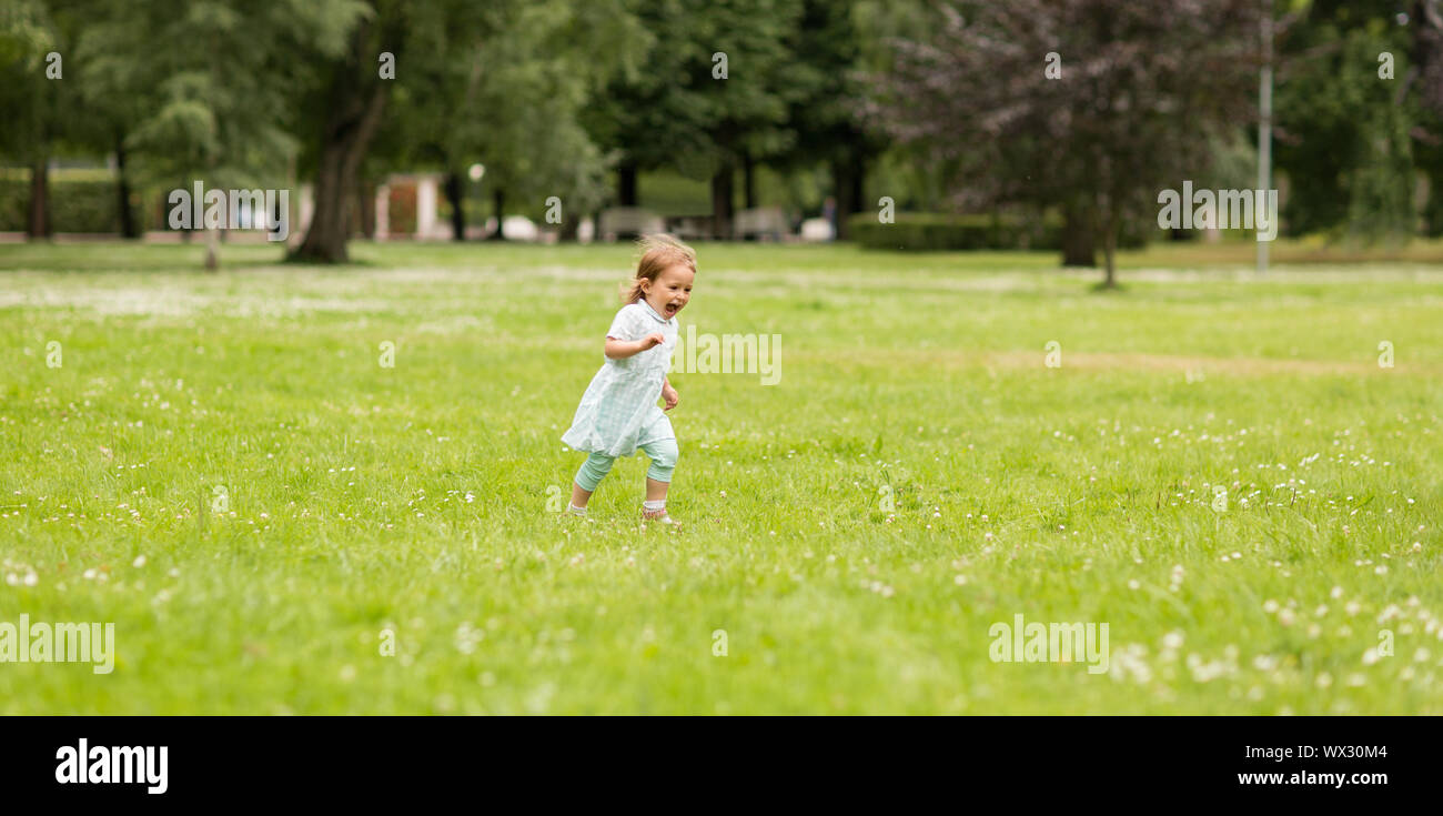 happy little baby girl running at park in summer Stock Photo - Alamy