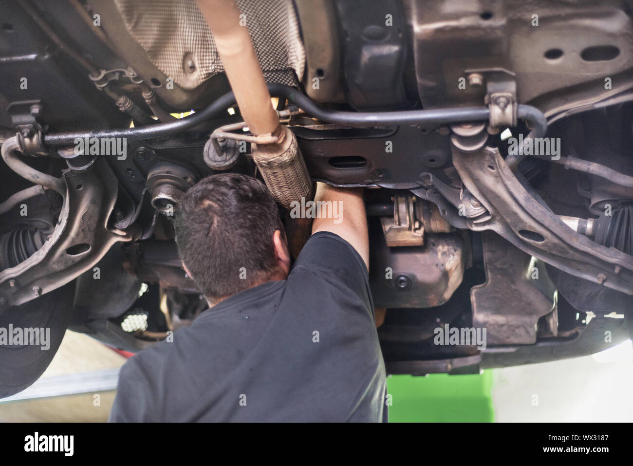 Mechanic repairing exhaust system Stock Photo Alamy