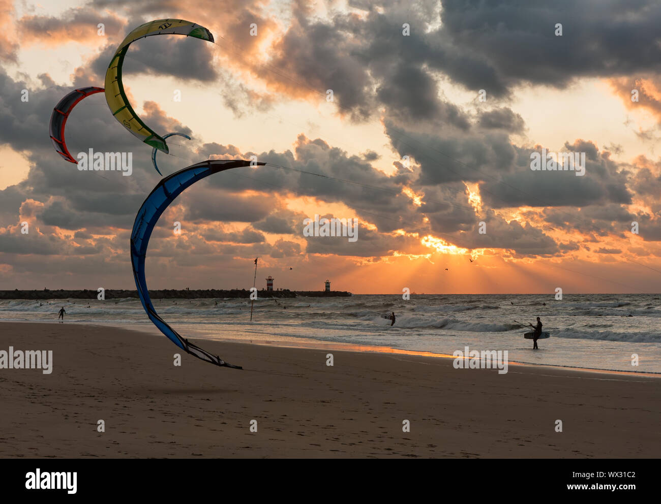 Kite surfing in the sunset at the beach of Scheveningen, the Netherlands Stock Photo