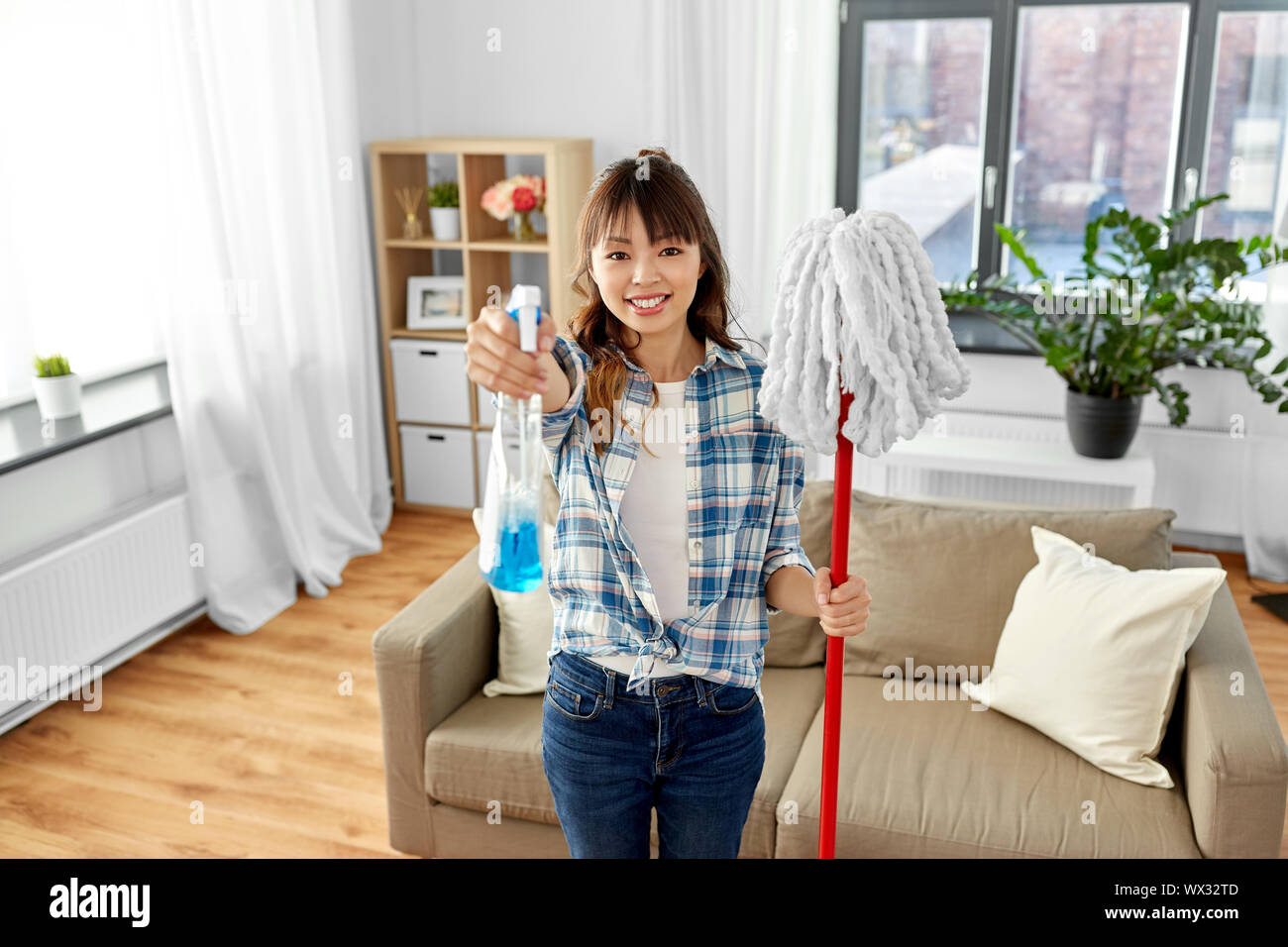 asian woman with mop and detergent cleaning home Stock Photo Alamy