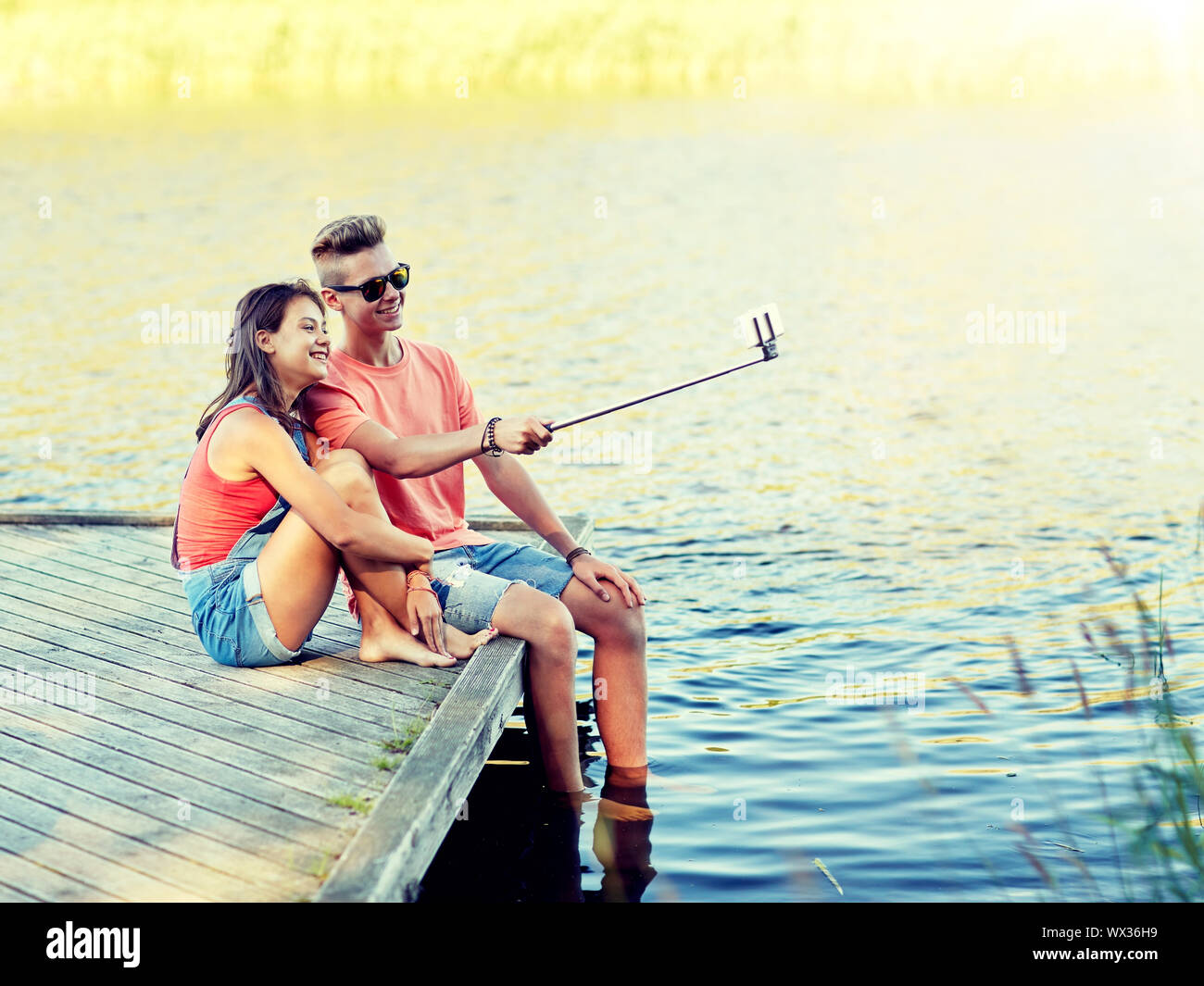 happy teenage couple taking selfie on smartphone Stock Photo - Alamy
