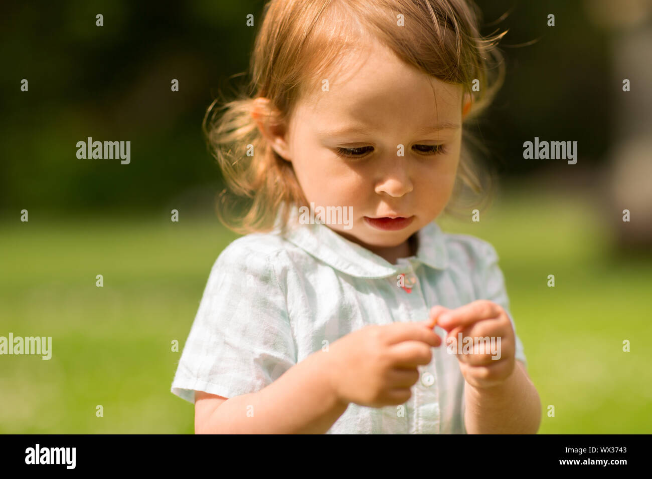 happy little girl at park in summer Stock Photo - Alamy