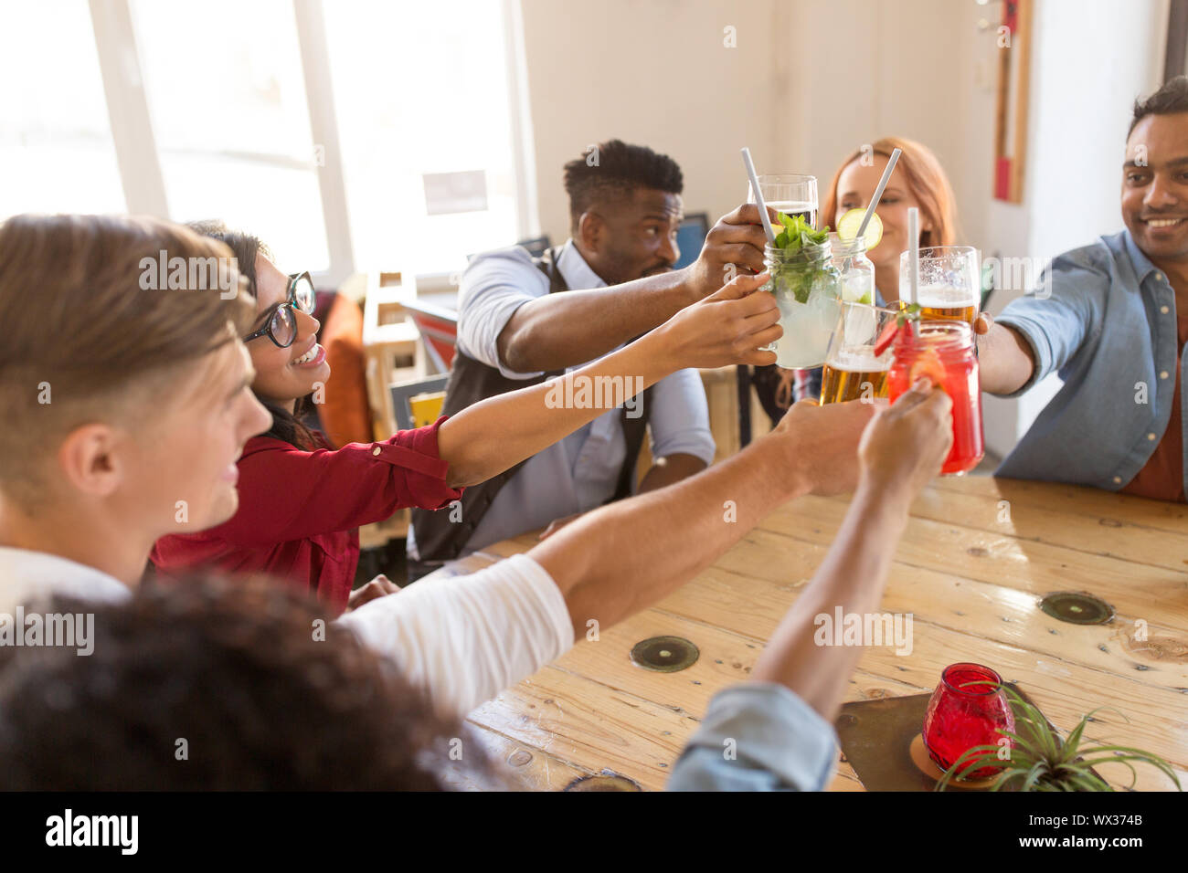 friends clinking glasses at bar or restaurant Stock Photo Alamy