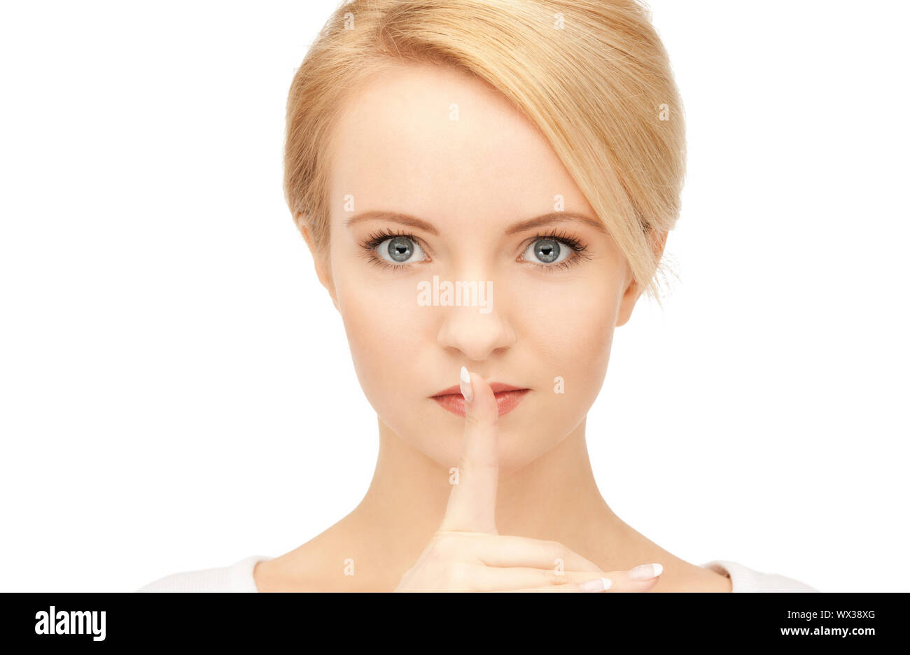 bright picture of young woman with finger on lips Stock Photo - Alamy