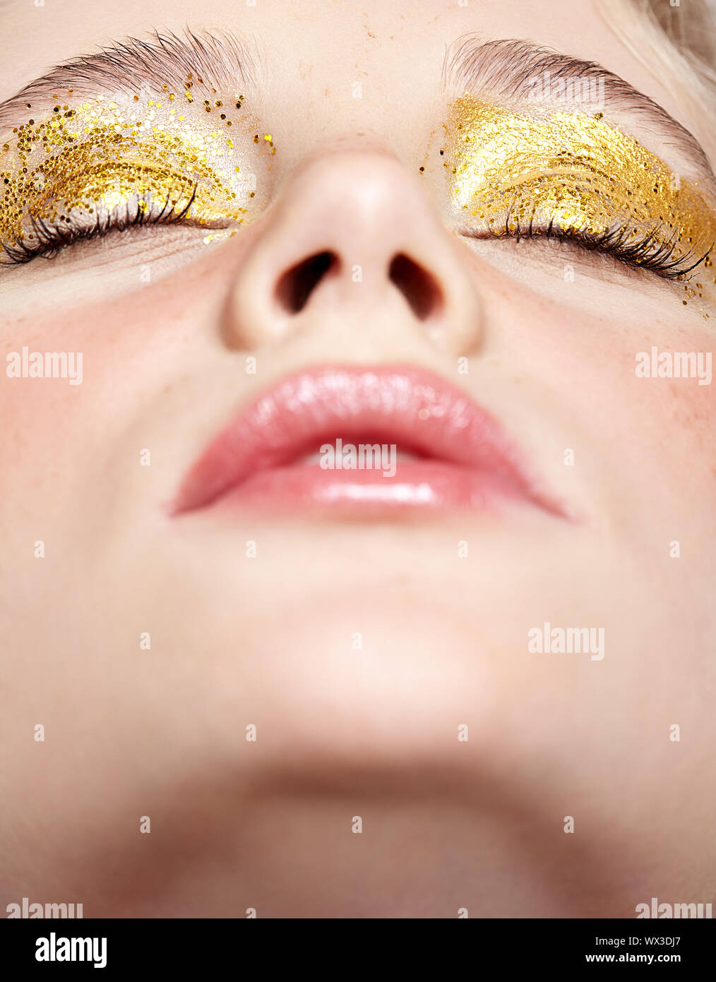 Closeup macro shot of closed human female face with yellow smoky eyes ...