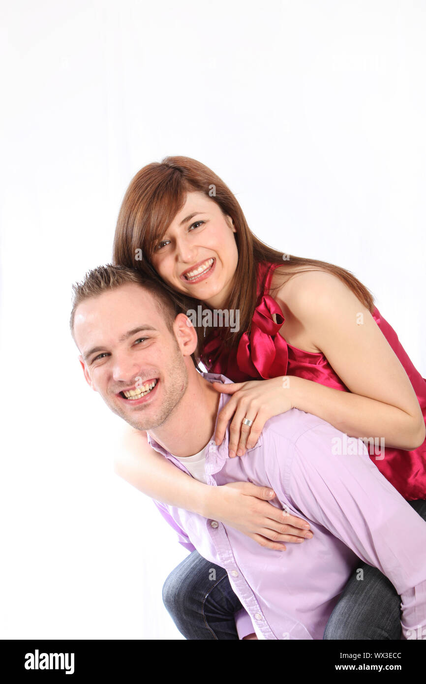 Young, smiling couple. He wears them on his back Stock Photo