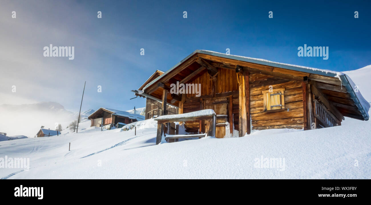 winter mountain landscape in Switzerland with wooden chalets and fresh ...