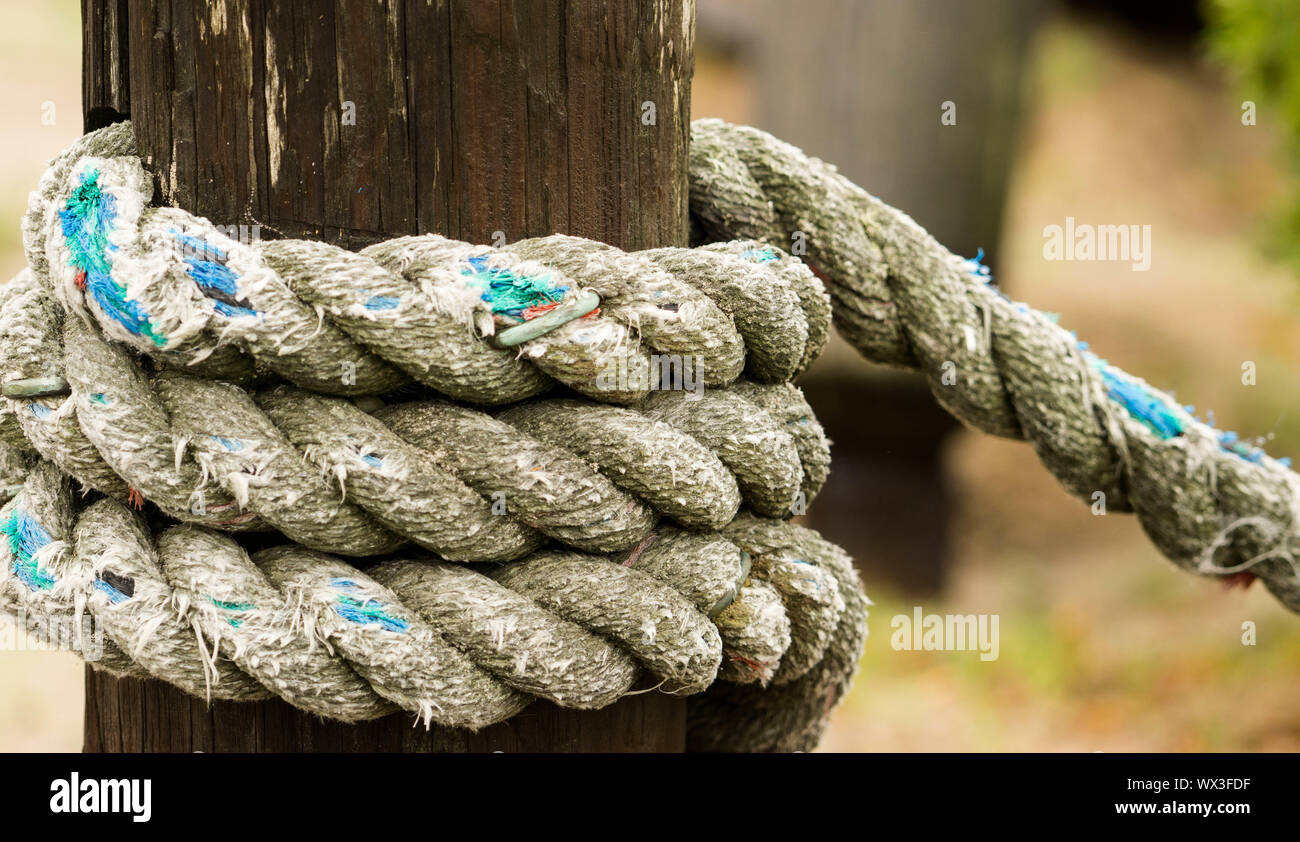 bollard and rope up close in a harbor Stock Photo