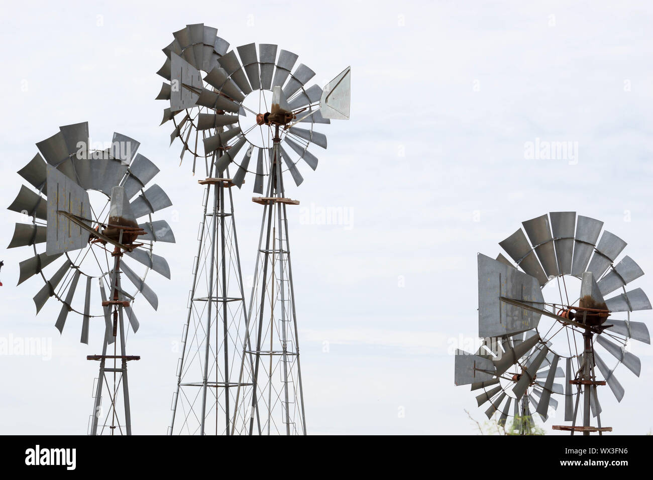 metal wind wheels under an overcast sky Stock Photo - Alamy