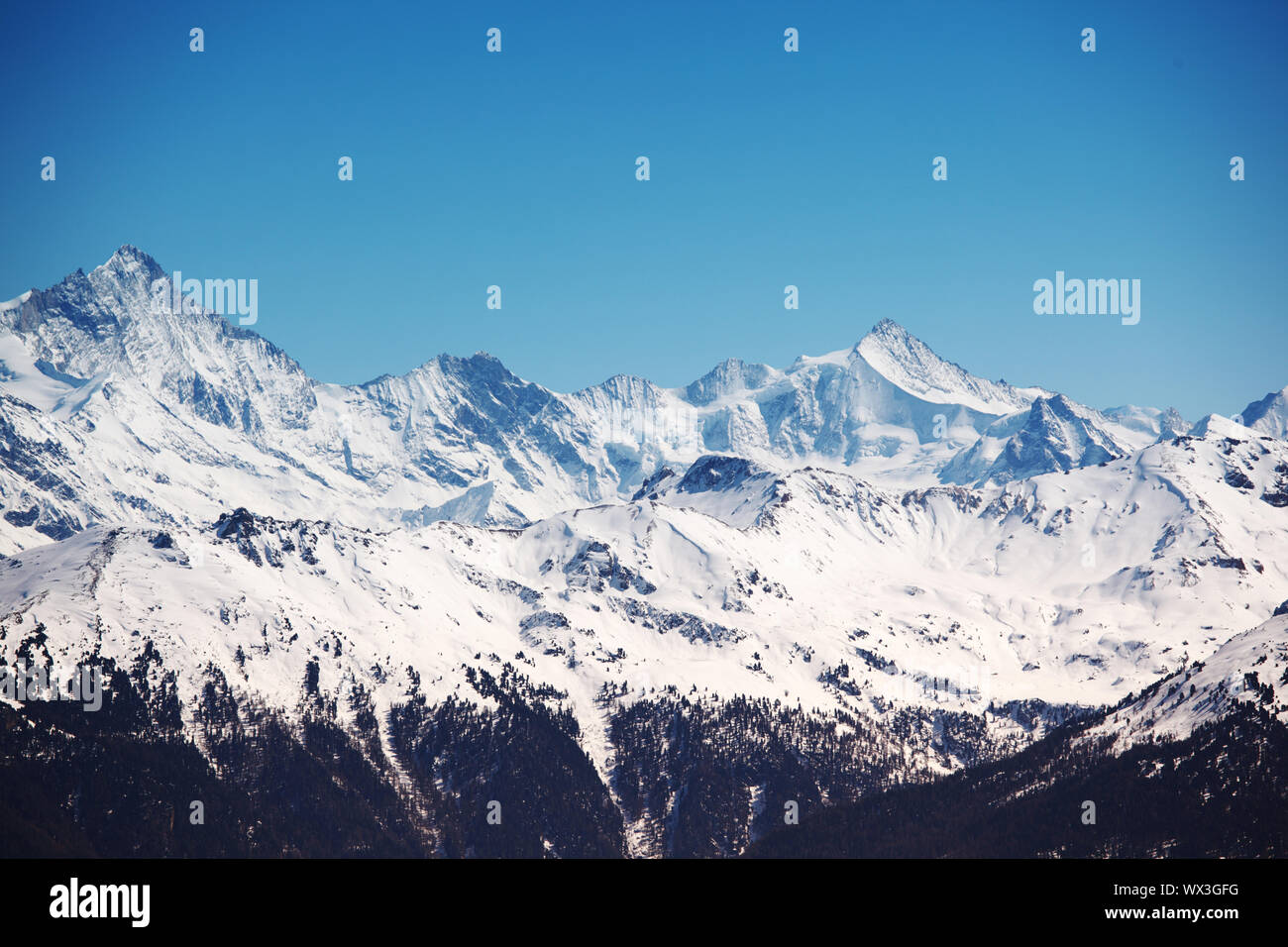 top of mountains sun in blue sky Stock Photo - Alamy