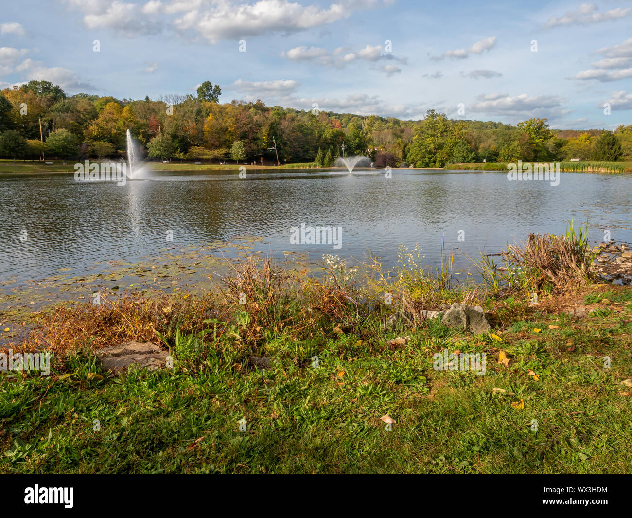 lake with water fountains in autumn in New Jersey, USA Stock Photo Alamy