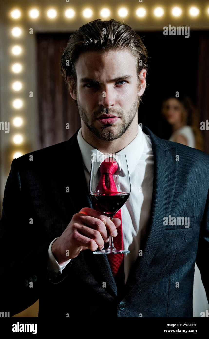 https://c8.alamy.com/comp/WX3HNE/man-hold-wine-glass-bearded-guy-in-office-style-clothes-at-restaurant-sommelier-near-woman-in-mirror-WX3HNE.jpg