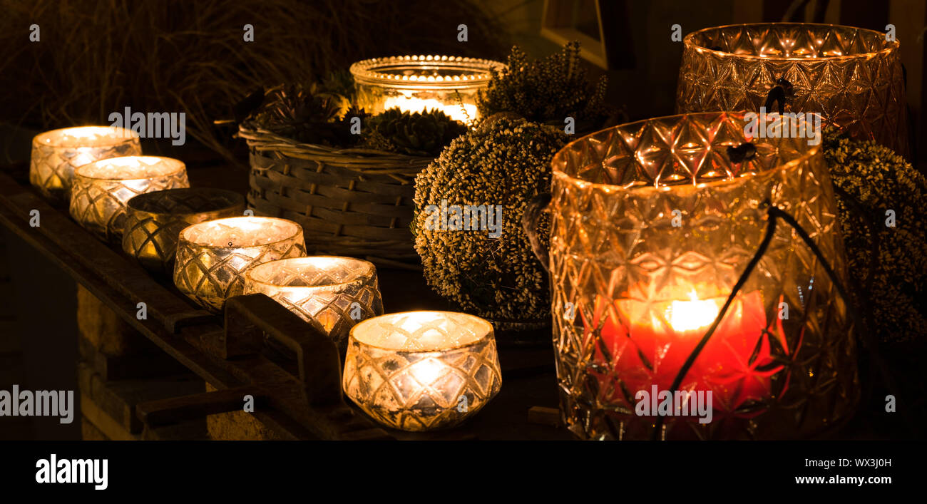 decorative and festive Christmas holiday arrangement with glasses and candles and assorted decorativ Stock Photo