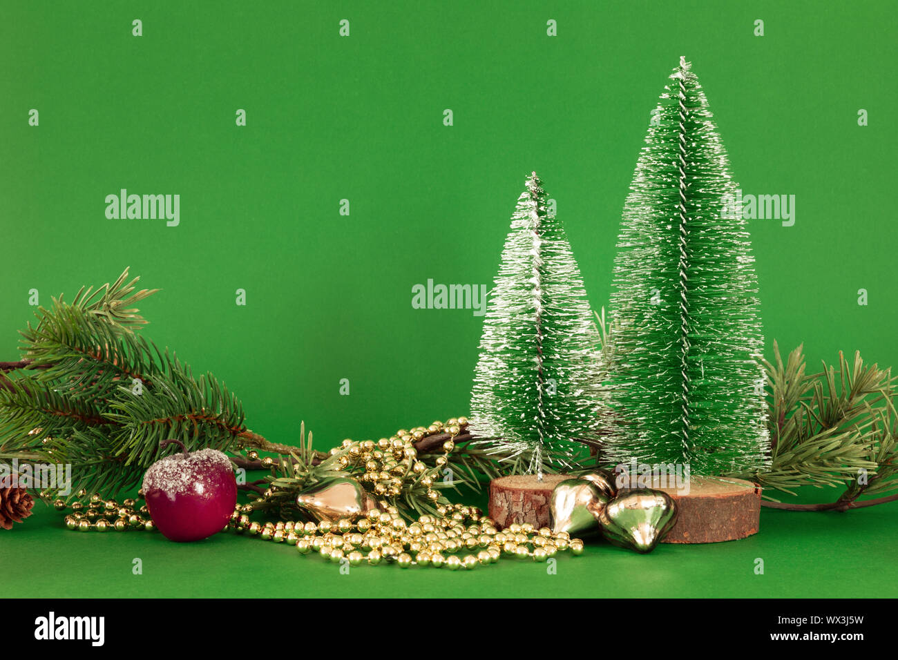 Christmas decoration green background with fir trees golden perls and ...