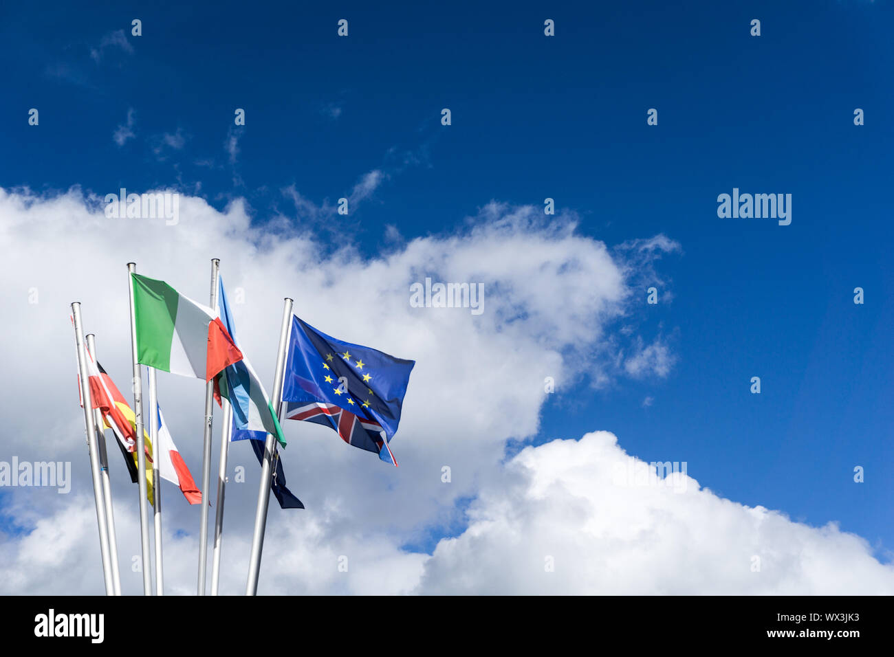 flags of the European Union in a blue sky with white clouds Stock Photo ...