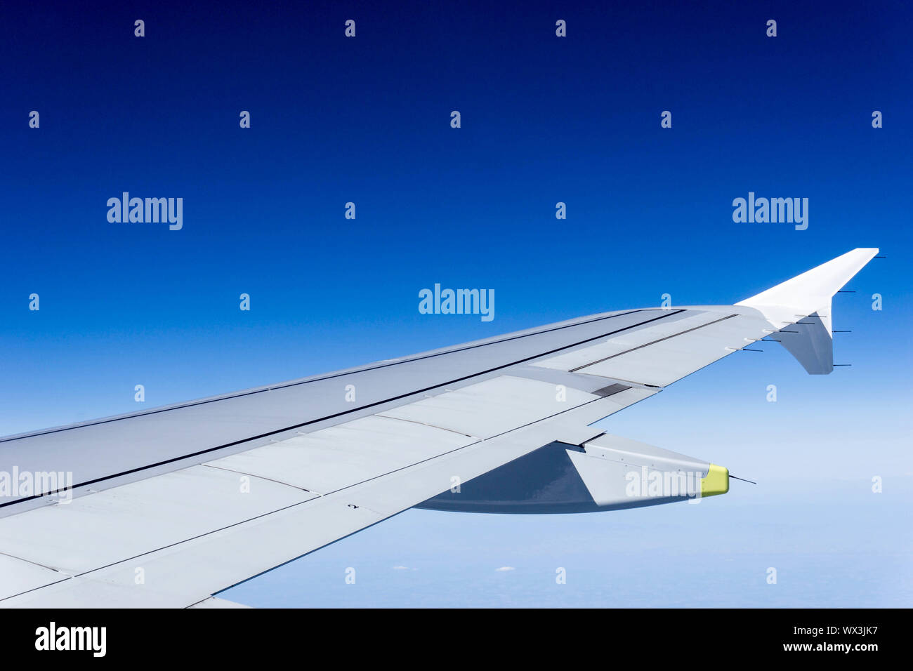 airplane wing in a blue sky above thick white clouds Stock Photo Alamy