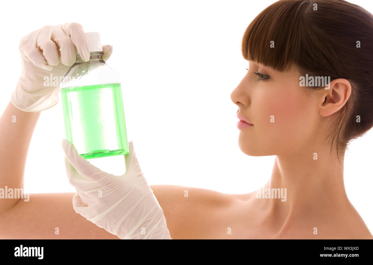 female lab worker holding up bottle with green liquid Stock Photo - Alamy