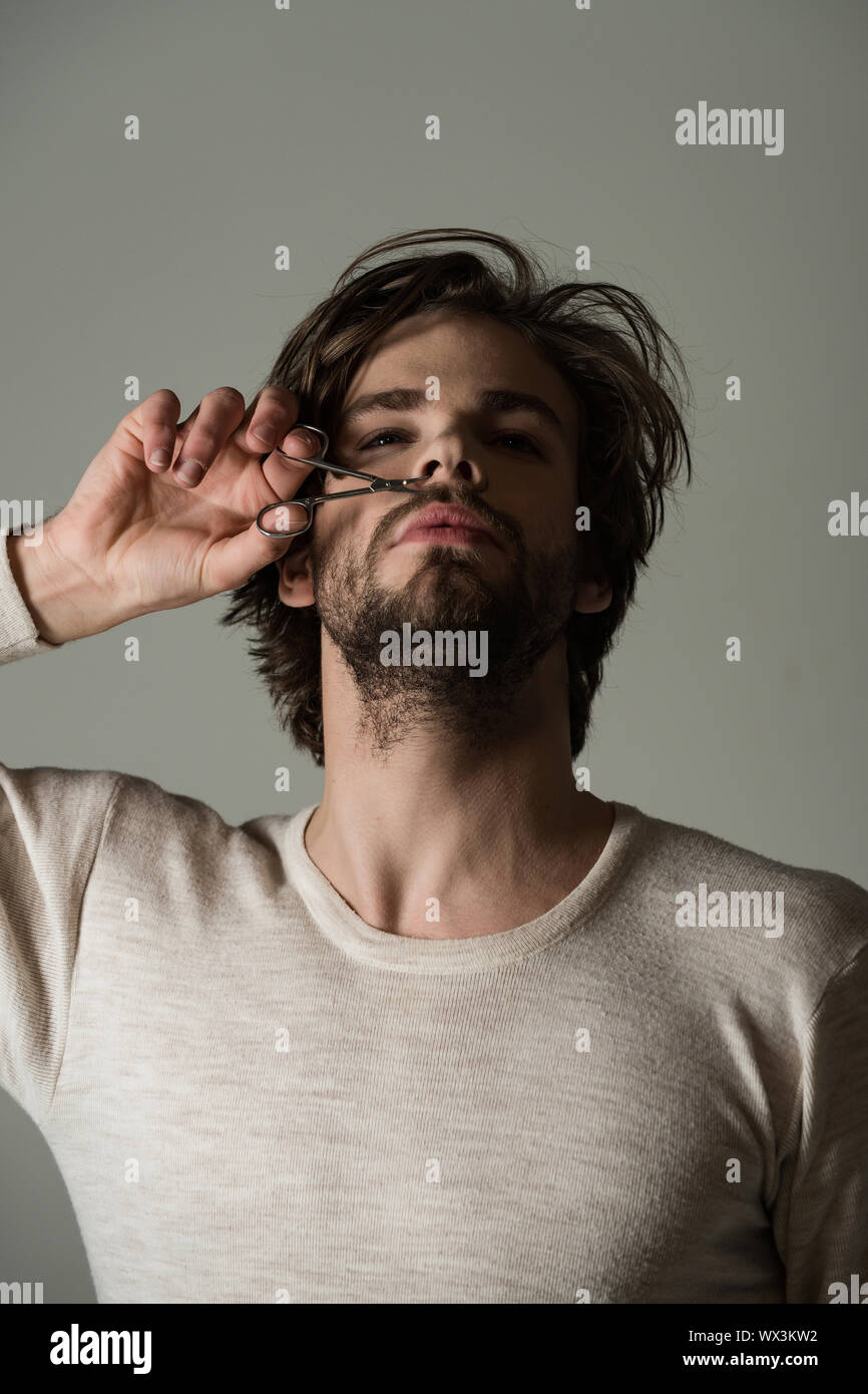 Man Trimming Nose Hair With Scissors Man With Disheveled Hair