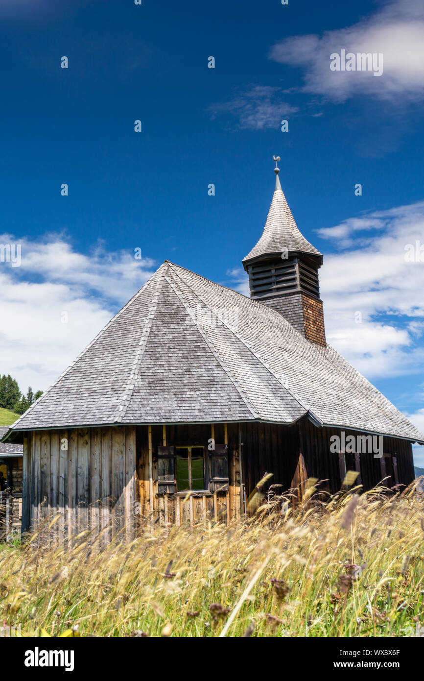 wooden larch church in the Swiss Alps in a small alpine village Stock ...