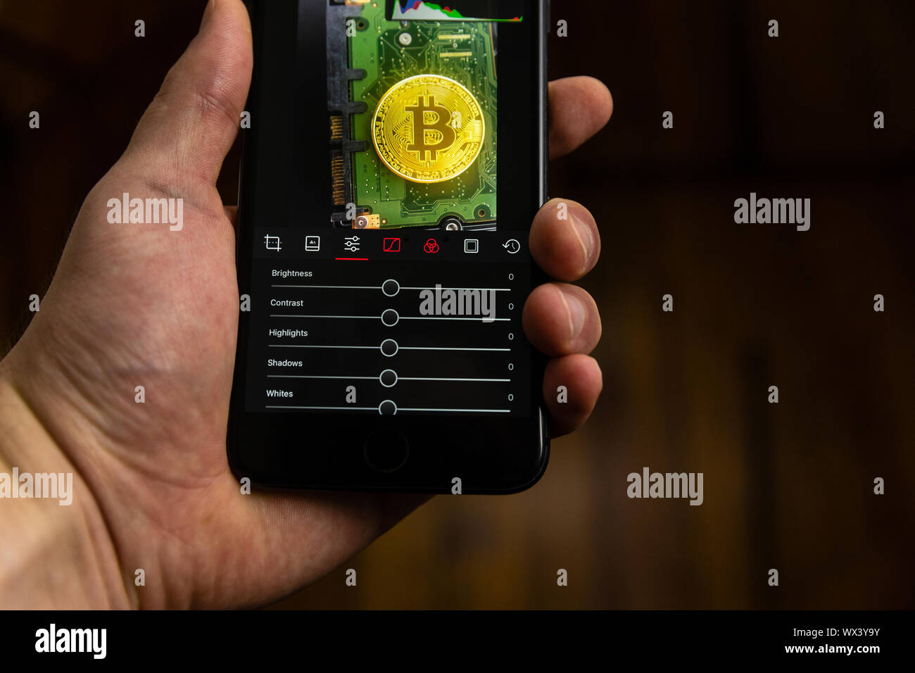 Editing a photo with a smartphone app Stock Photo