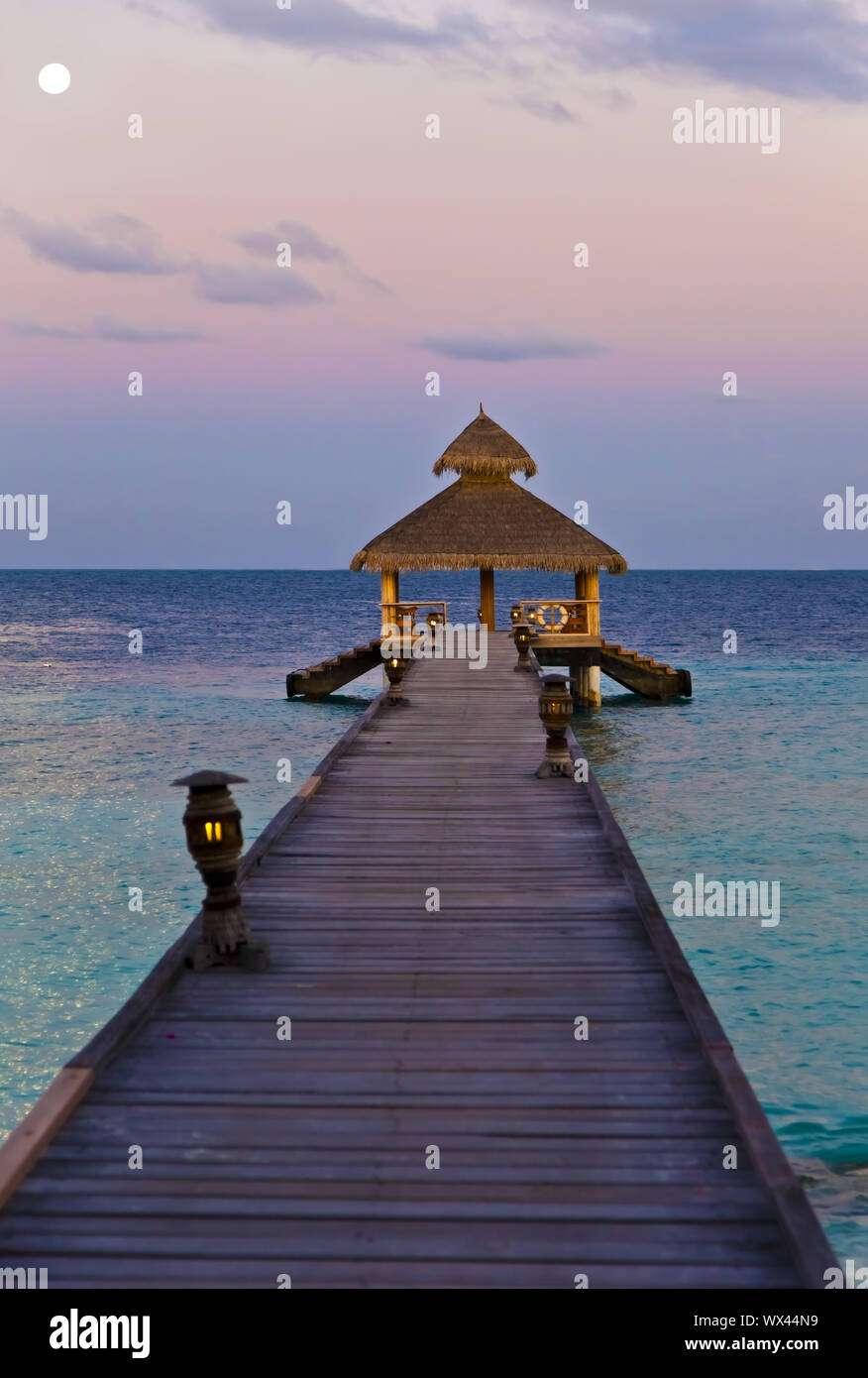 Jetty in the moonlight on the Maldives Stock Photo