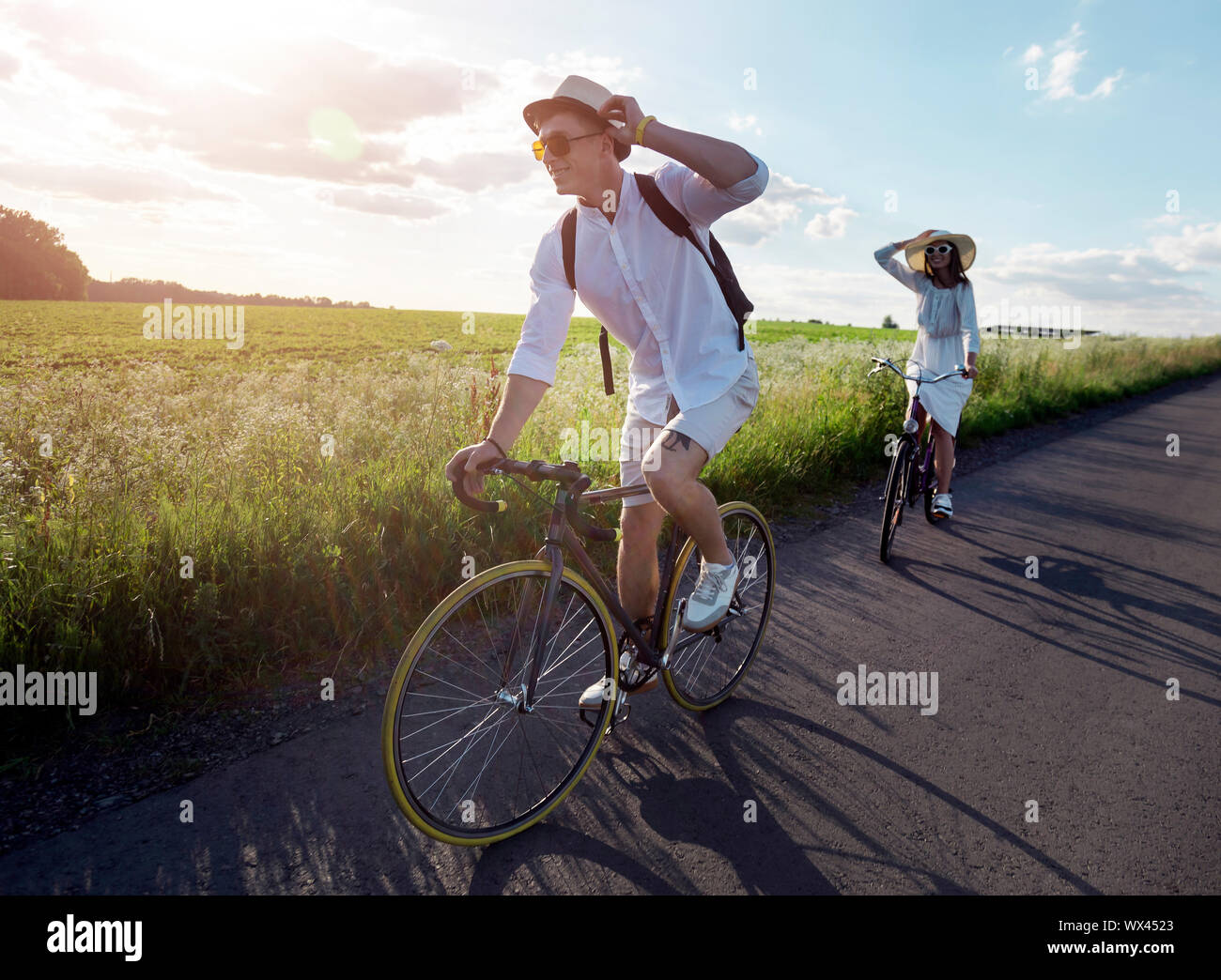 Young couple has a bicycle trip at summer countryside Stock Photo