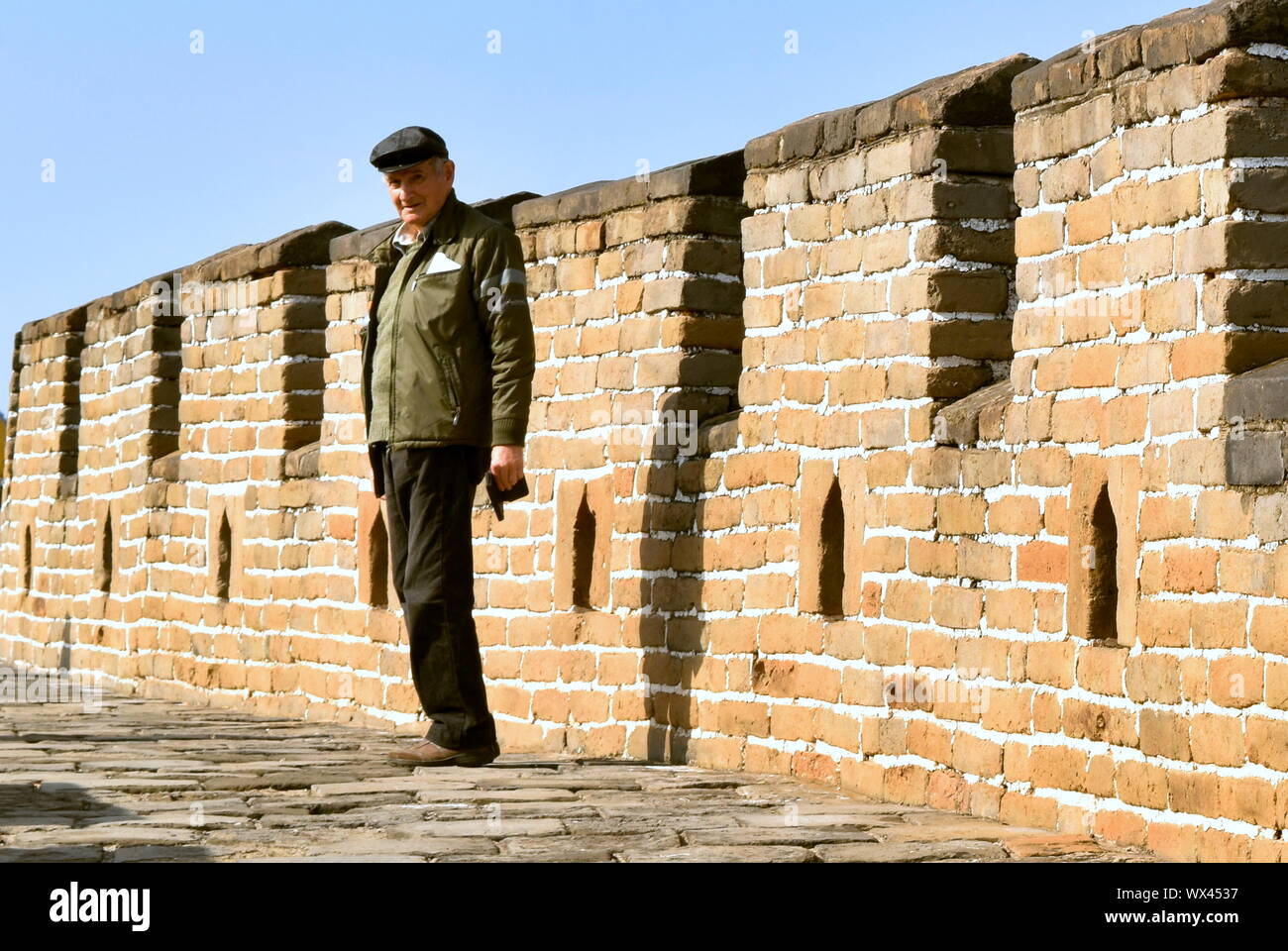 Active senior tourist man hikes along Great Wall of China, Mutianyu, China Stock Photo