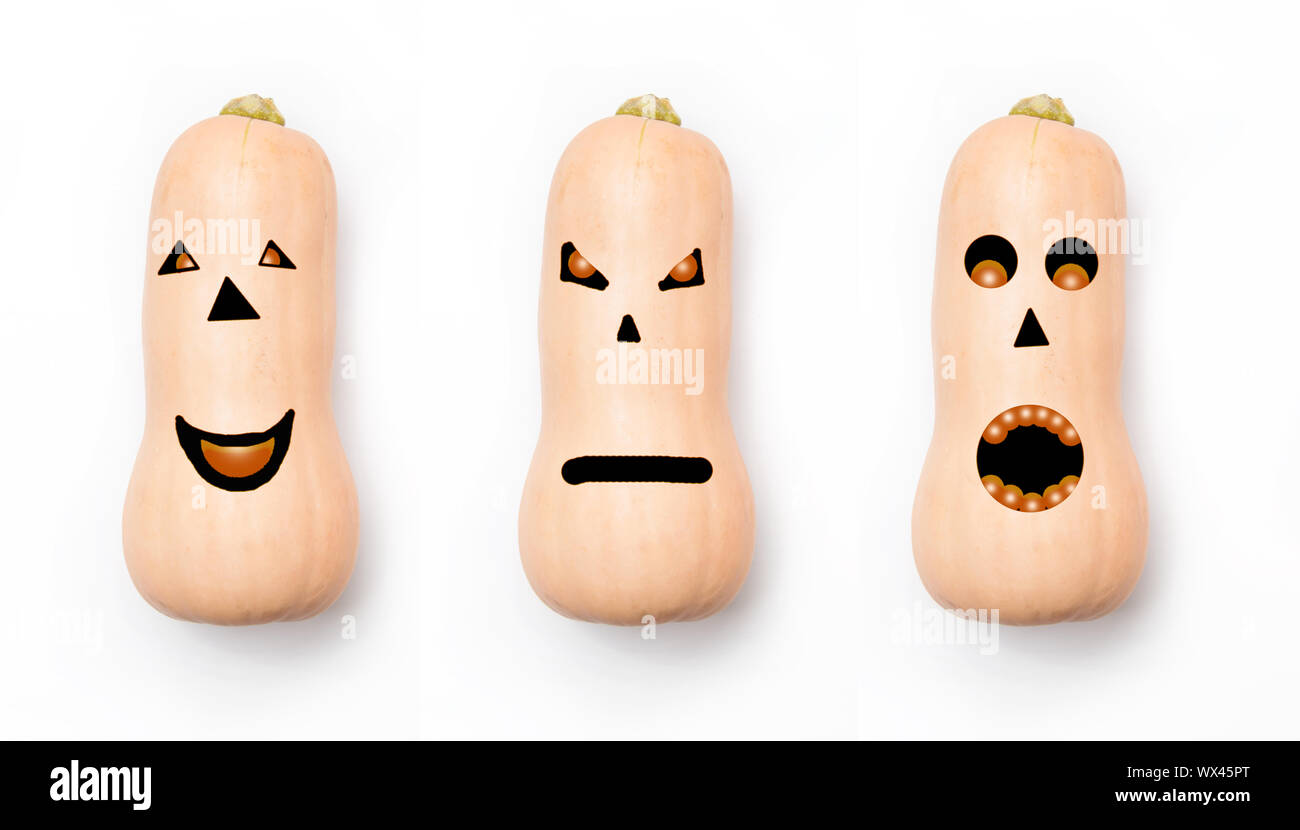 Three pumpkins with different faces on a white background. Concept for halloween. Stock Photo