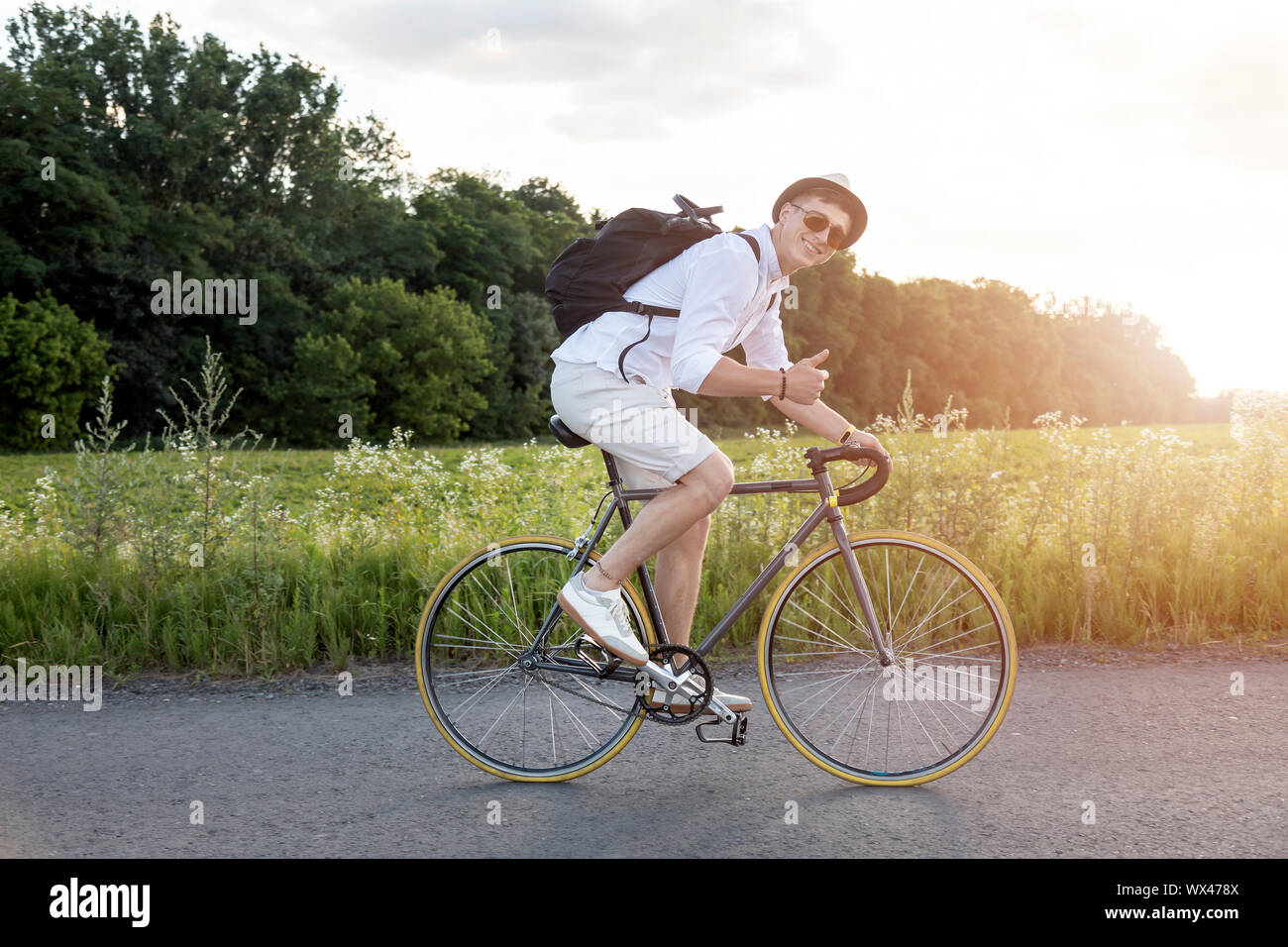 Young casual lad enjoying his rural area bike trip Stock Photo