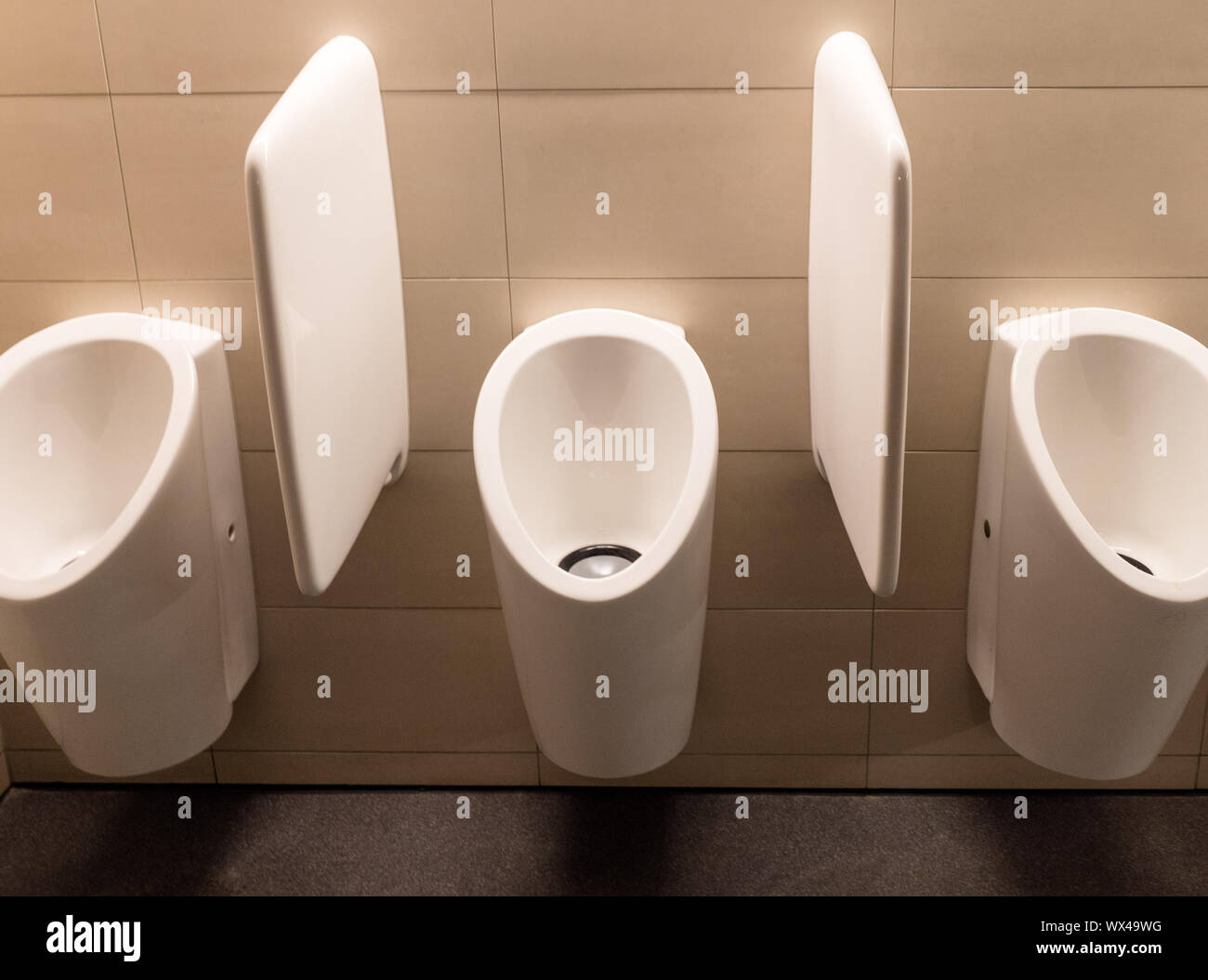 Urinals In The Men's Bathroom With White Ceramic Urinals Design Of White Men  In The Toilet. Stock Photo, Picture and Royalty Free Image. Image 54213166.