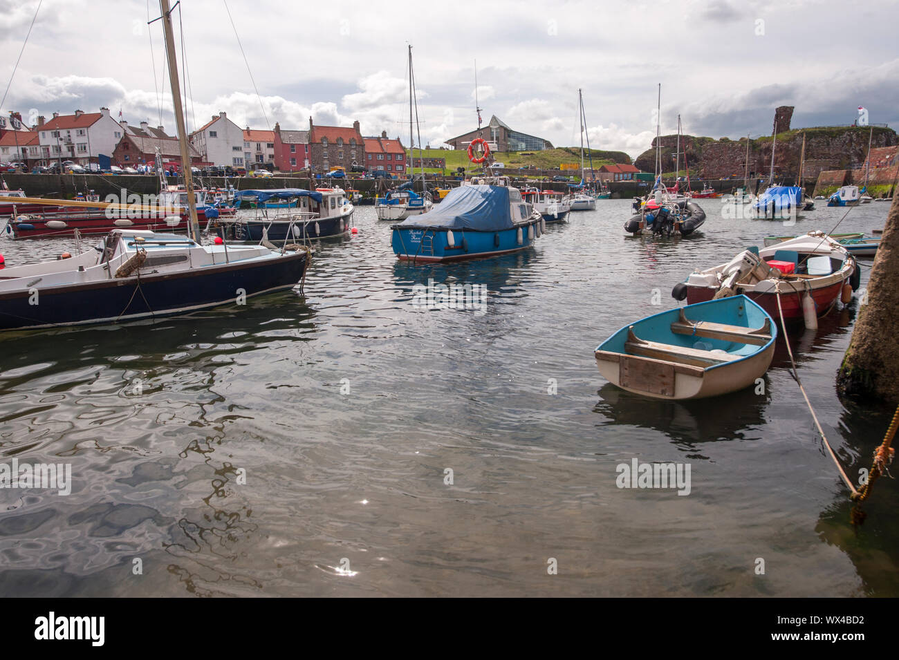 Boats and houses in Dunbar harbour during low tide. Dunbar is a town