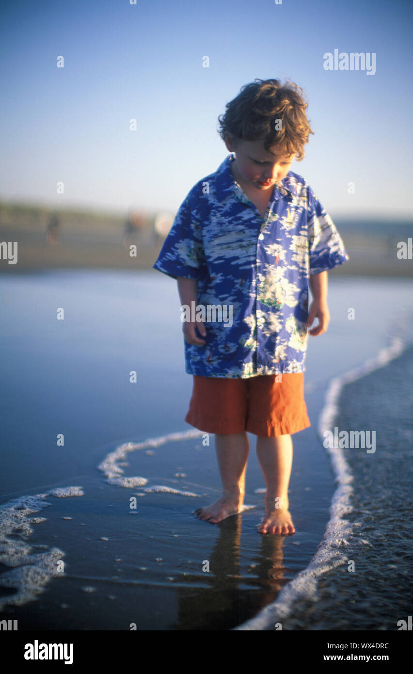A child takes a stroll on a beach Stock Photo Alamy
